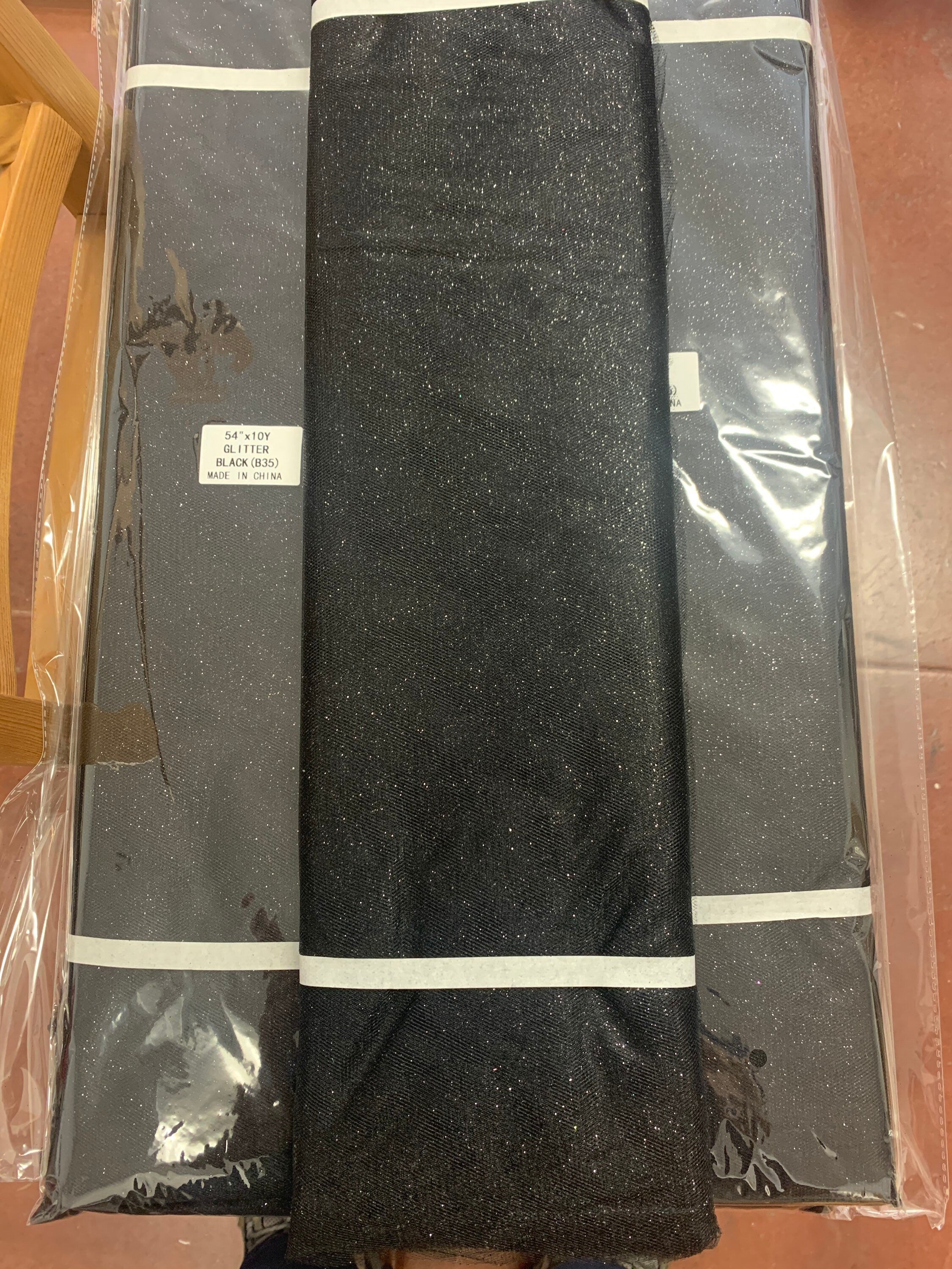 Black Glitter Tulle 54" double fold, color Black with Silver glitter 10 yards per pack.