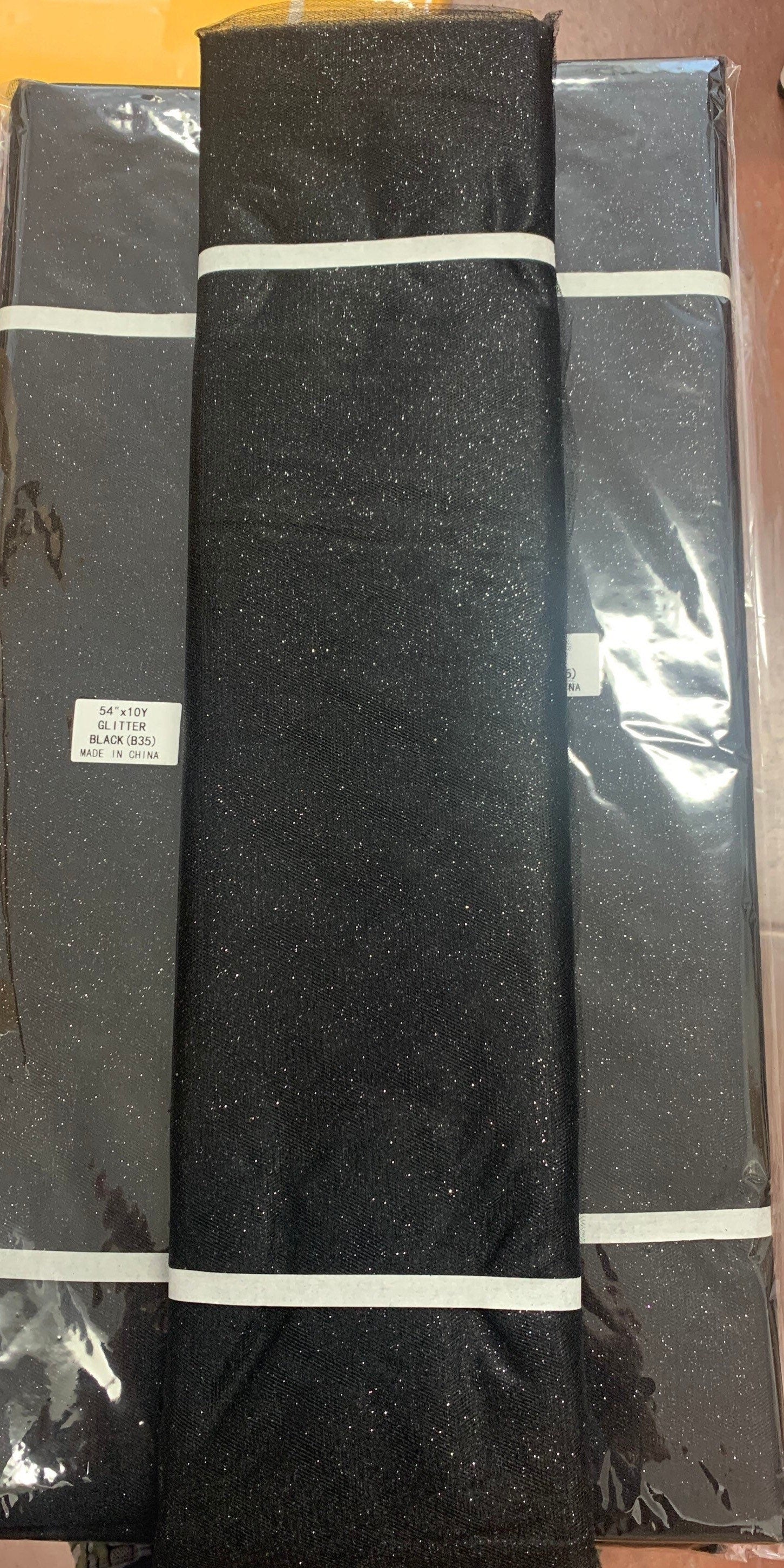 Black Glitter Tulle 54" double fold, color Black with Silver glitter 10 yards per pack.