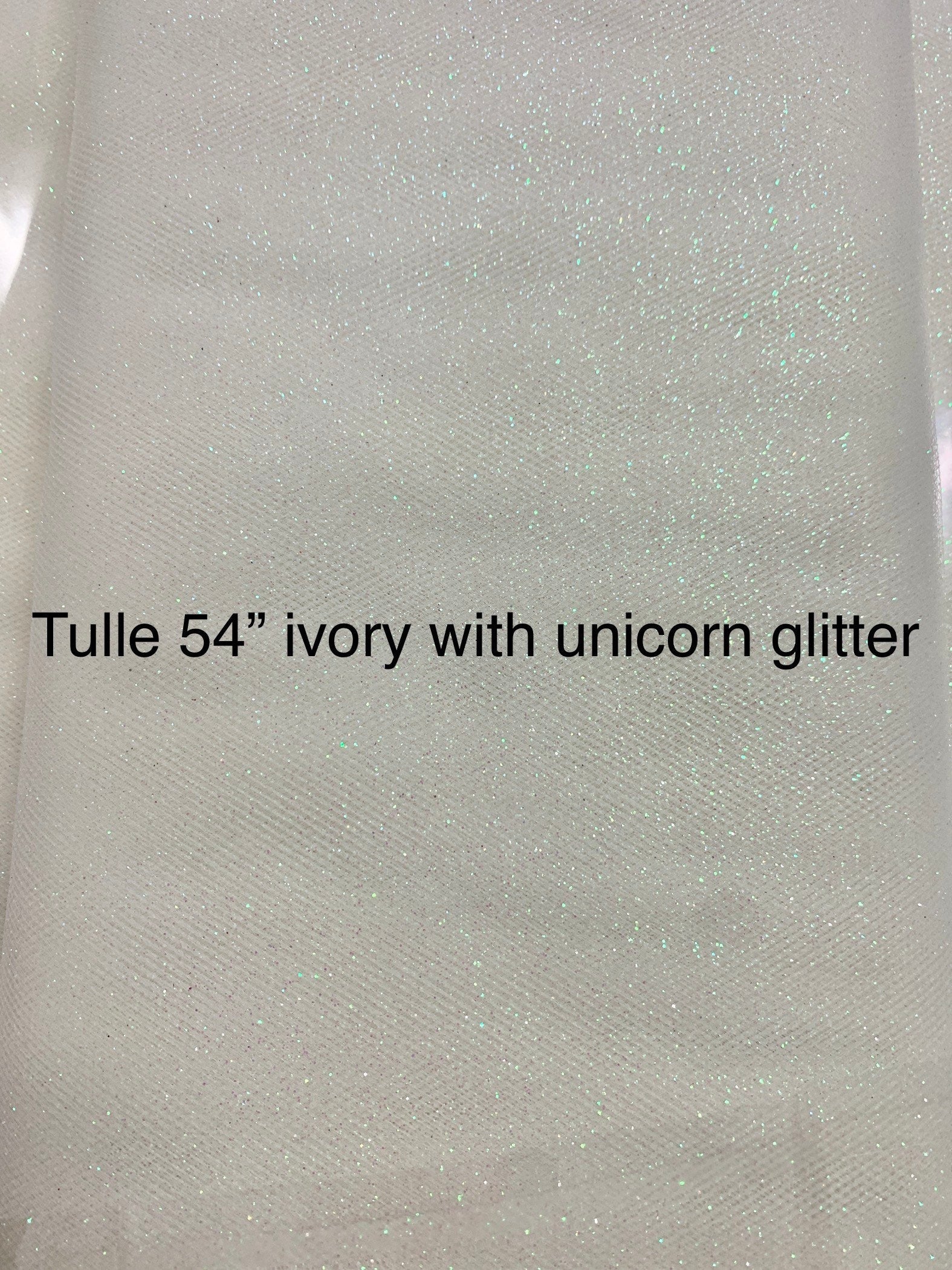 Ivory Tulle Gliter 54" double fold, color Ivory with unicorn glitter 10 yards per pack.