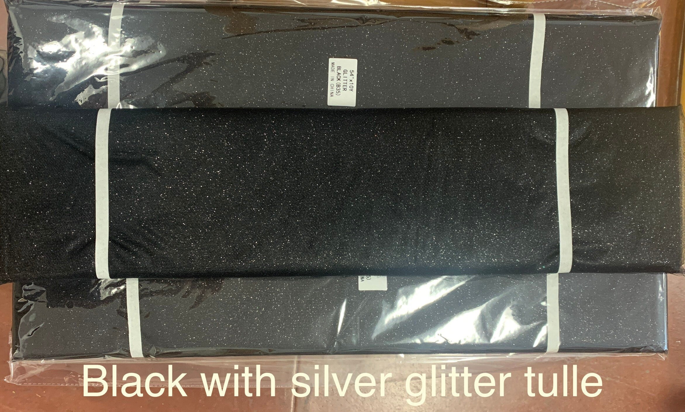 Black Glitter Tulle 54" double fold, color Black with Silver glitter 10 yards per pack.