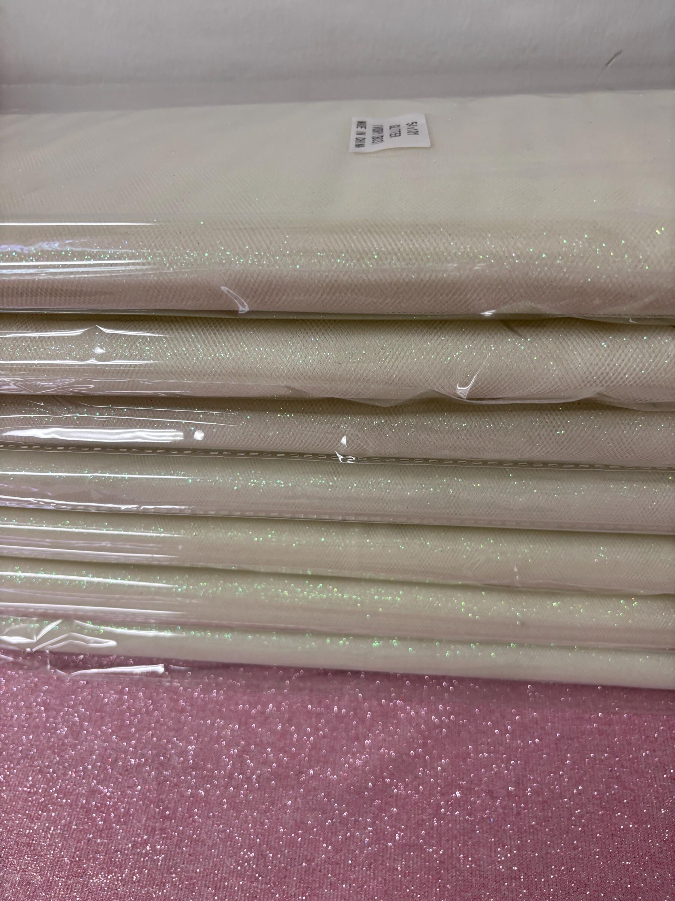 Ivory Tulle Gliter 54" double fold, color Ivory with unicorn glitter 10 yards per pack.