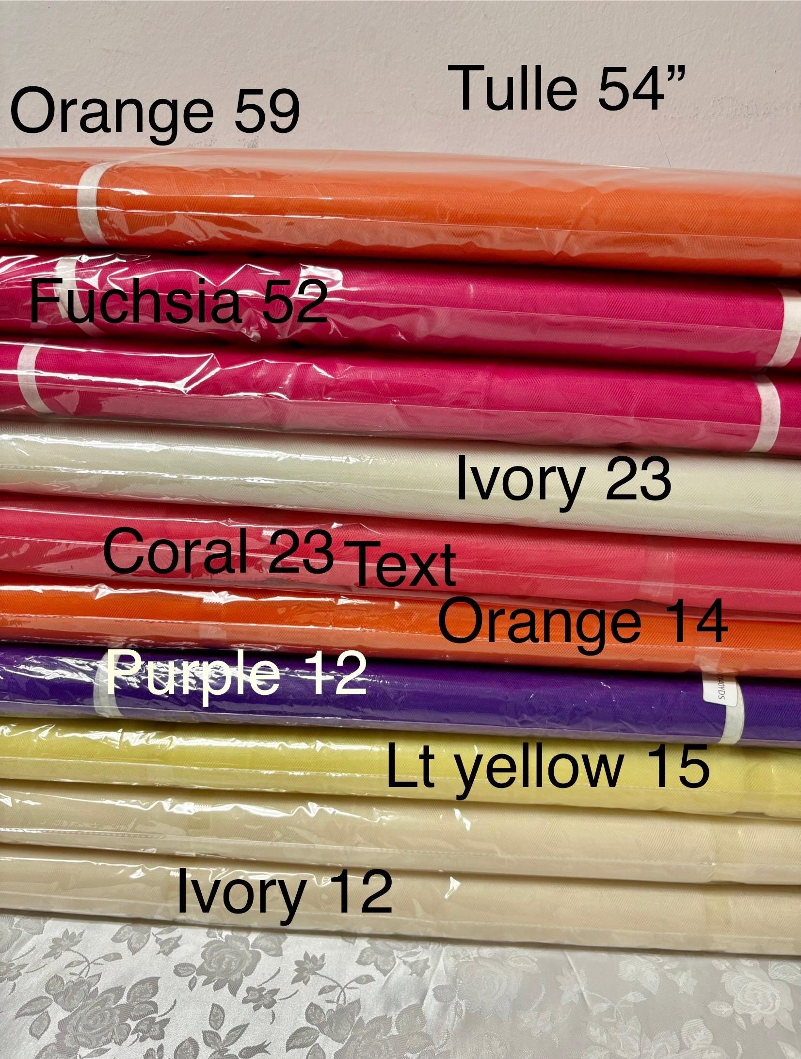 May include: A stack of colorful tulle fabric rolls. The colors include orange, fuchsia, ivory, coral, purple, and light yellow. Each roll is labeled with its color and a number, such as 'Orange 59' and 'Fuchsia 52'. The fabric is tightly rolled and wrapped in clear plastic.,