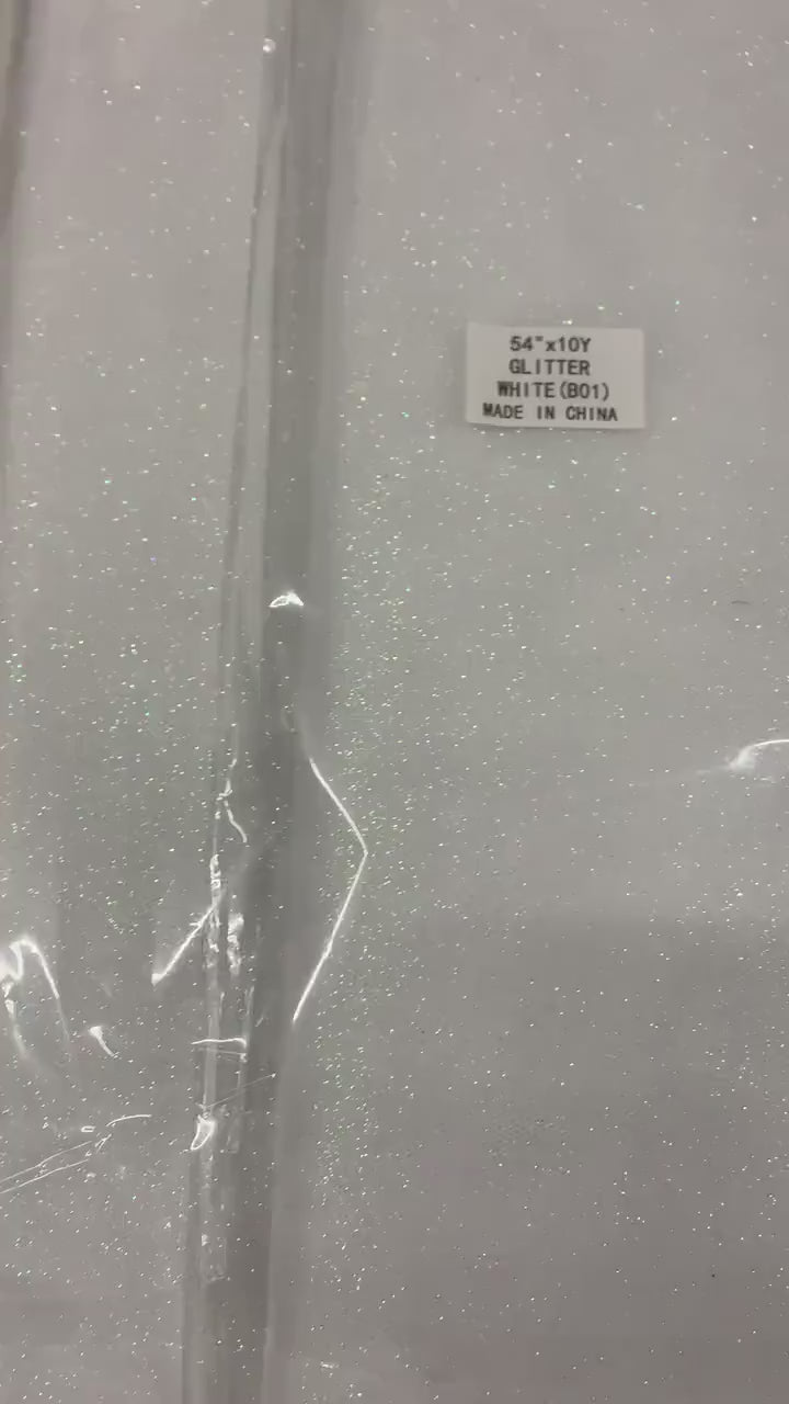 White Gliter Tulle 54" double fold white with unicorn gliter 10 yards per pack.