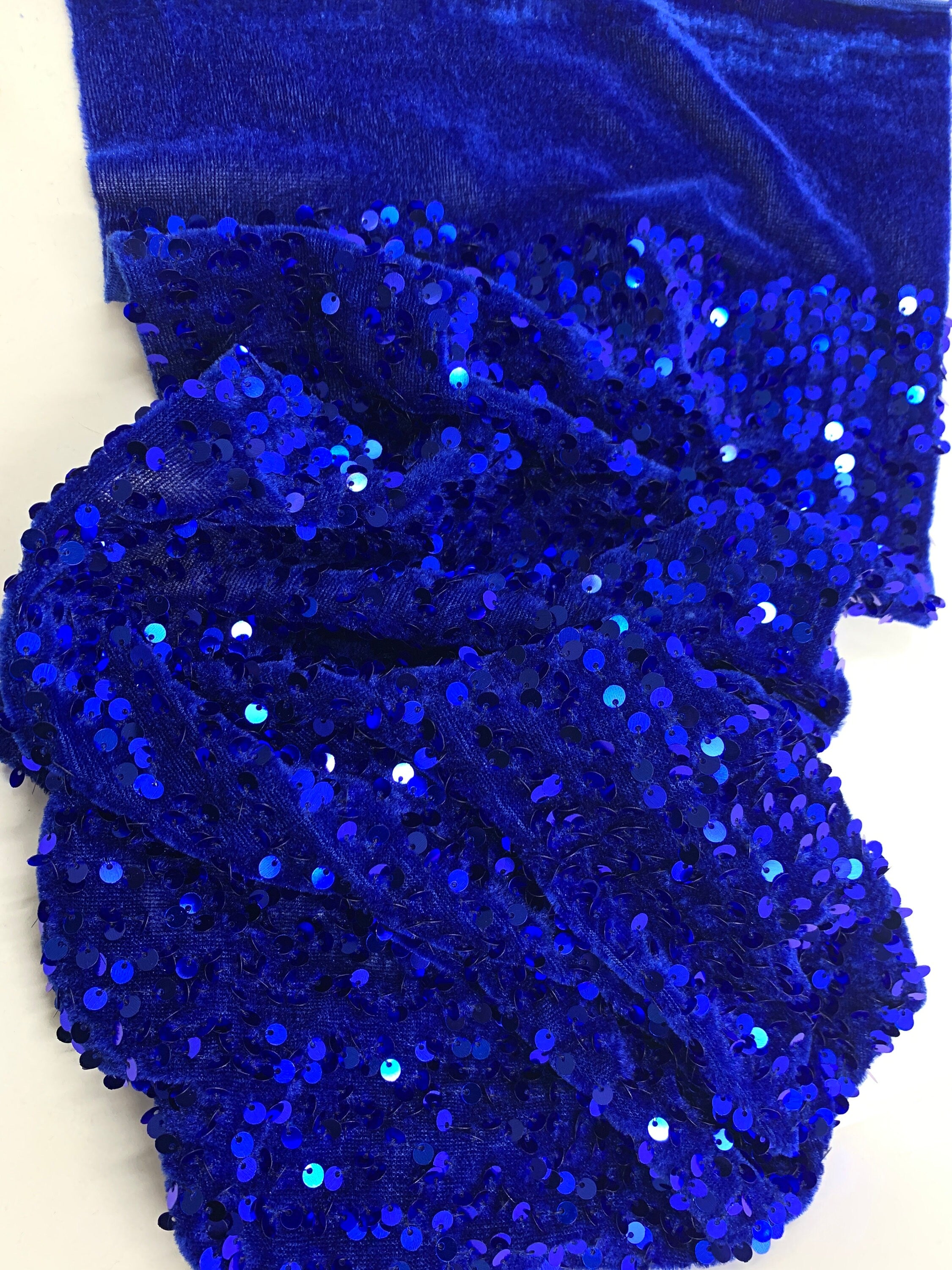 Pane velour sequins fabric. color royal blue, polyester yarn and metallic sewn sequins width is 58/59” with plain salvage of 3” both side