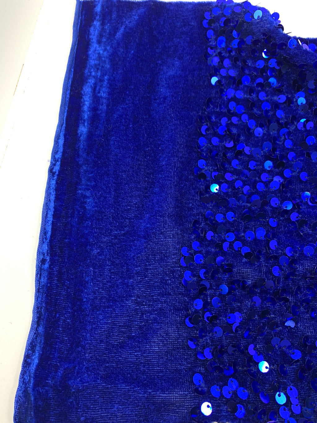 Pane velour sequins fabric. color royal blue, polyester yarn and metallic sewn sequins width is 58/59” with plain salvage of 3” both side