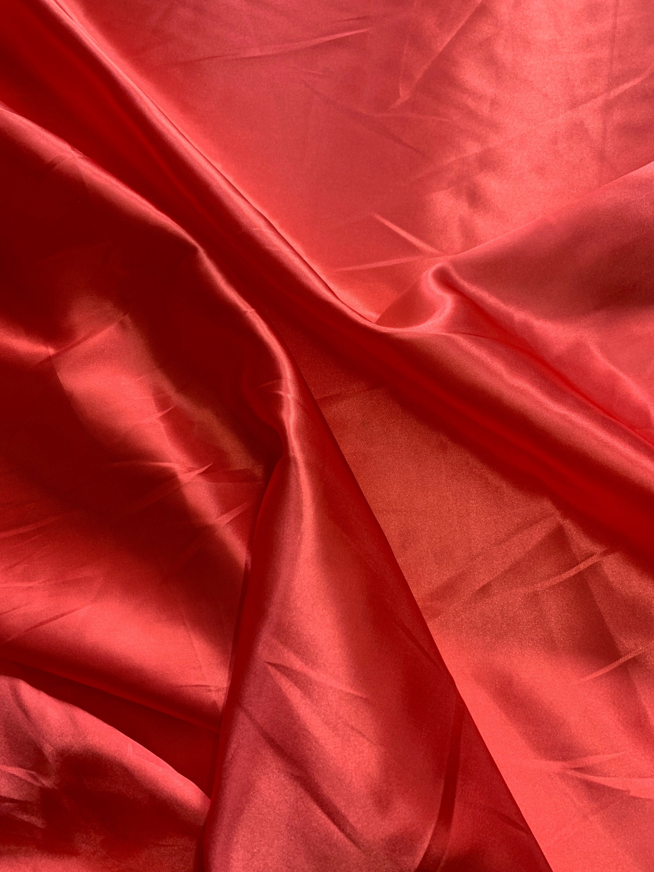 Red charmeuse satin 100% polyester color is dark coral. Lustrous , smooth fabric, shiny on front and matte in back
