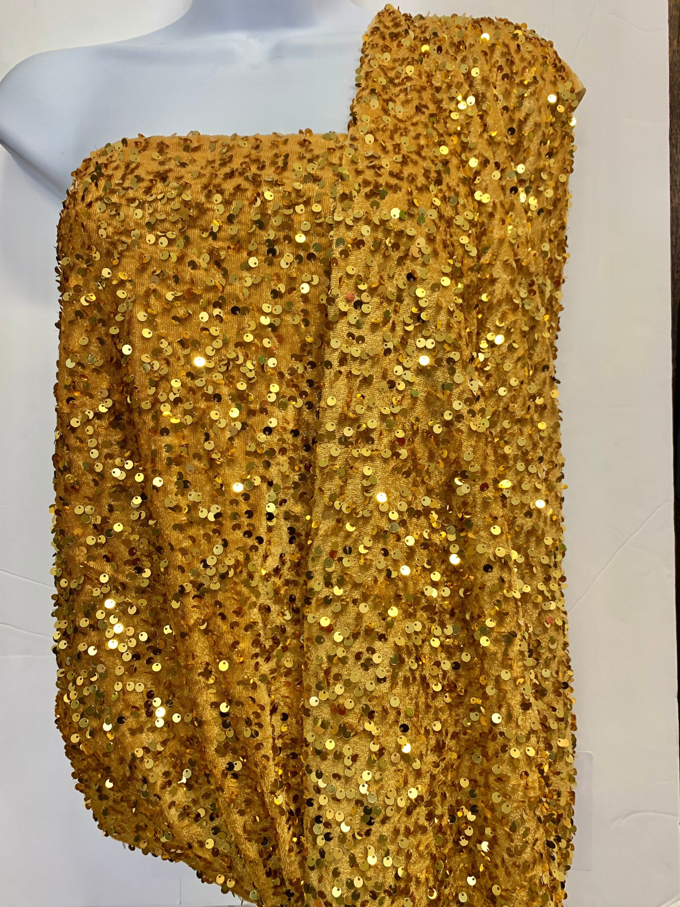Pane velour sequins fabric, color gold width 59/60" 100% polyester. Sells in 1-yard increments, continuous.