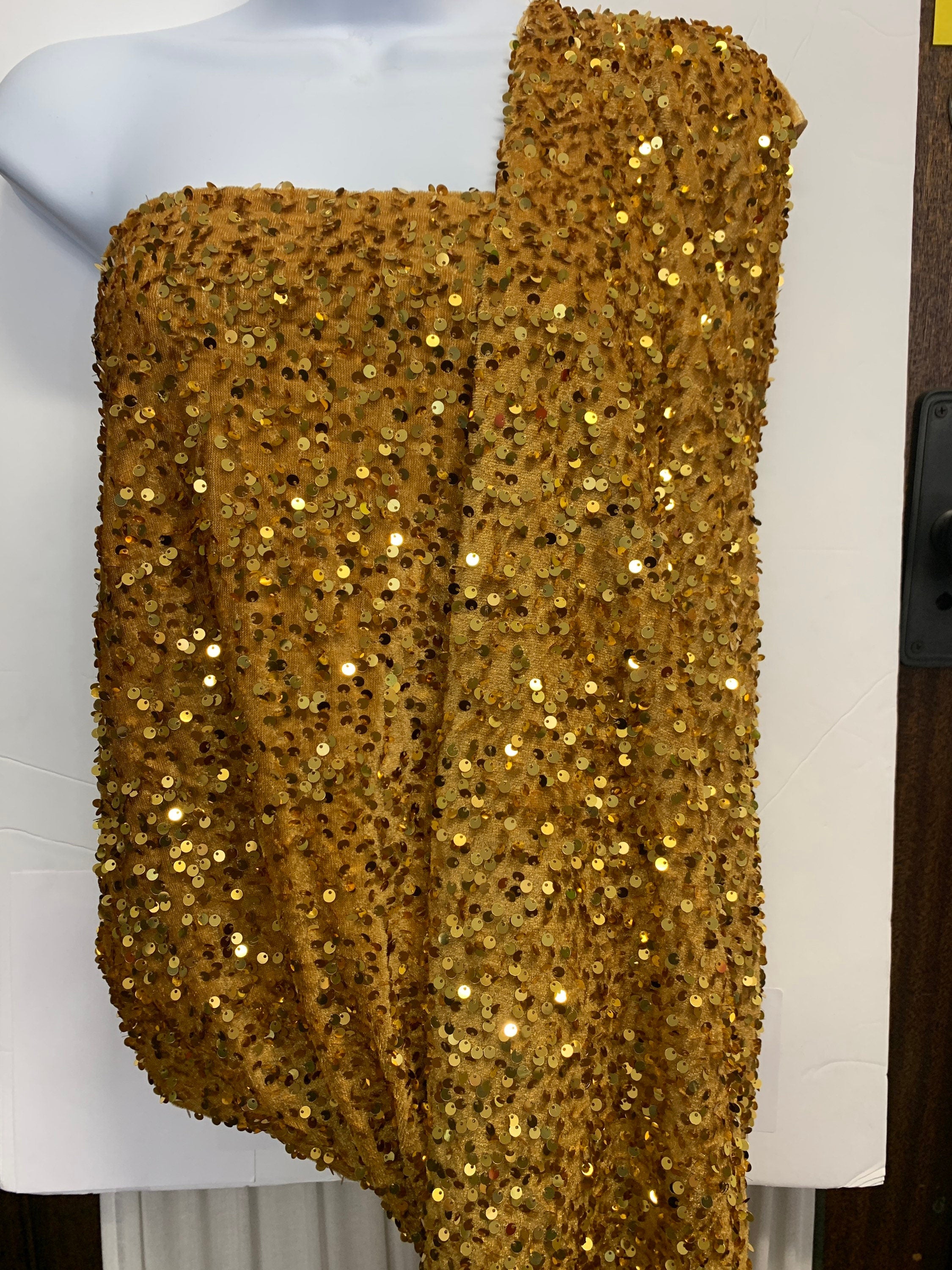 Pane velour sequins fabric, color gold width 59/60" 100% polyester. Sells in 1-yard increments, continuous.