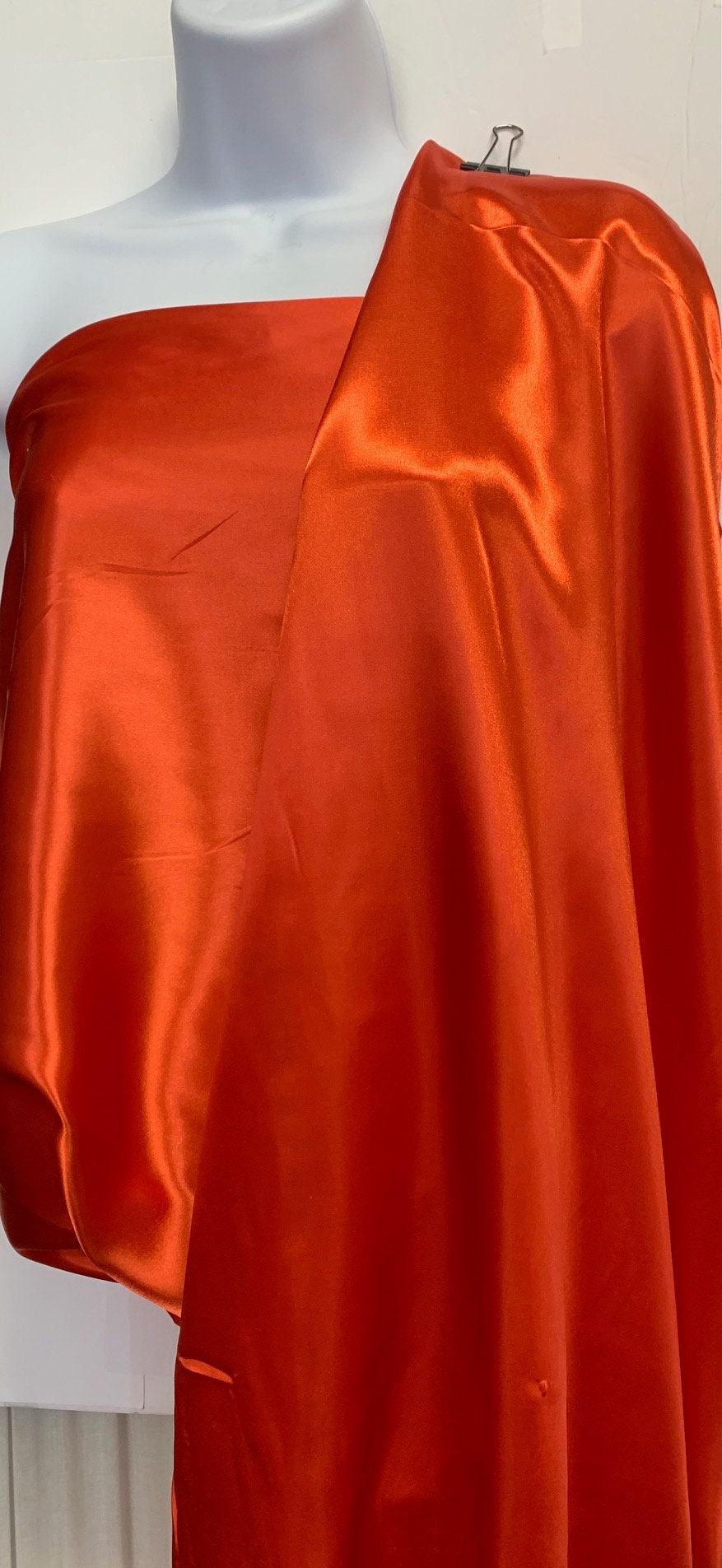 Soft silky satin fabric, width 58/60 inches 100% polyester color Coral known as Charmeuse satin fabric suitable for lingerie and apparel.