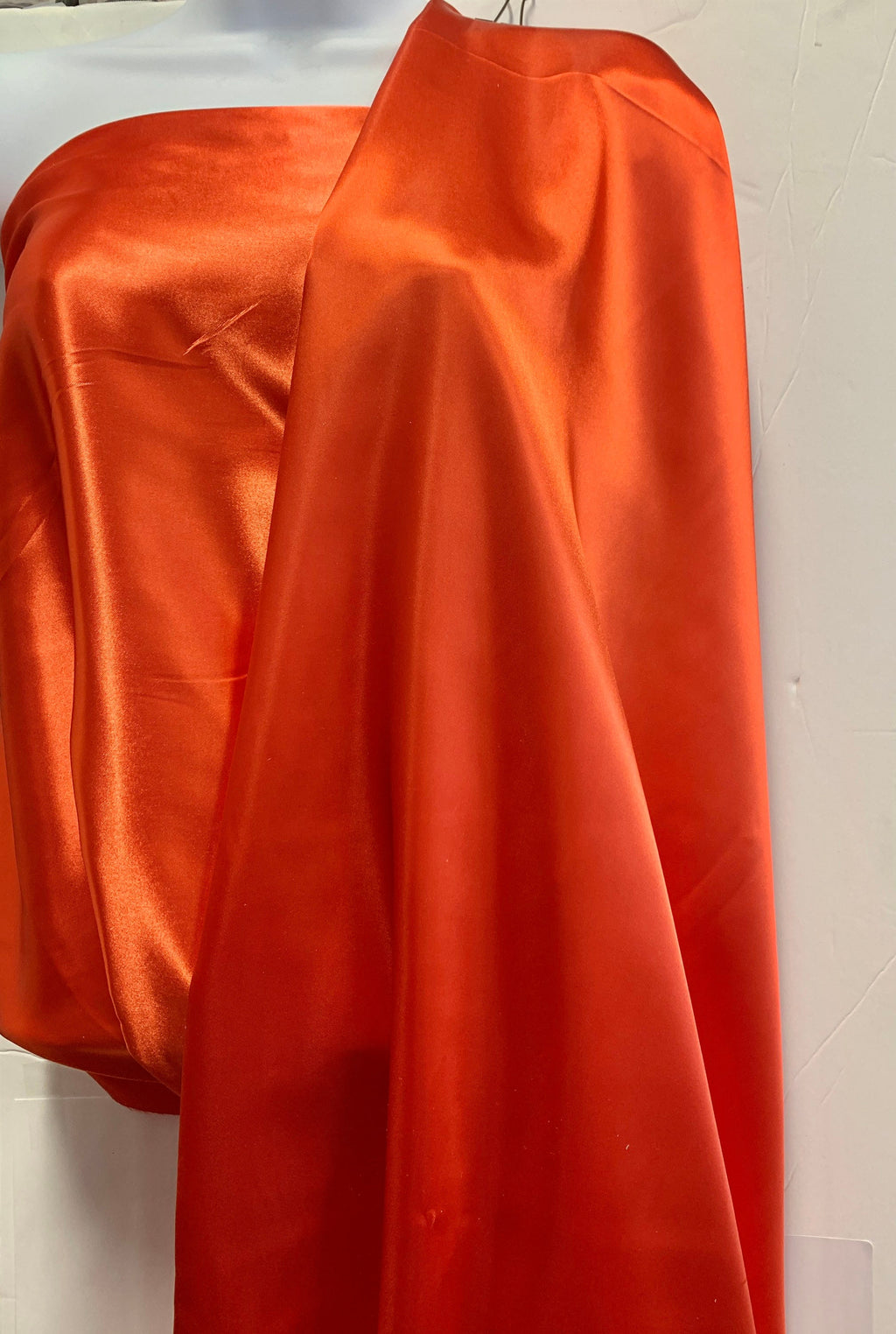 Soft silky satin fabric, width 58/60 inches 100% polyester color Coral known as Charmeuse satin fabric suitable for lingerie and apparel.