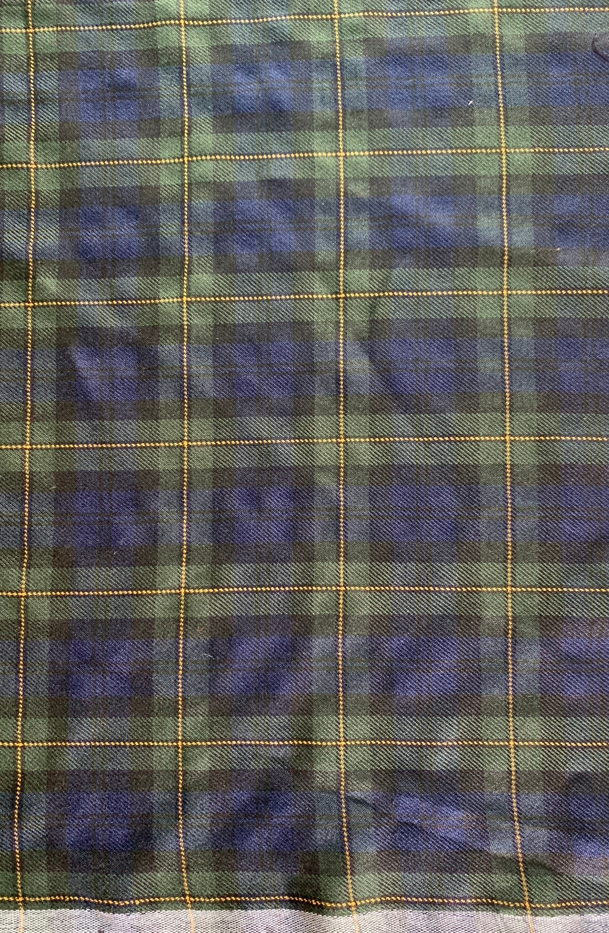 Plaid design fabric. Width 59 inches made of polyester and rayon cross dyed yarn colors in red and green.