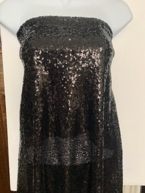 Black Sequins Mesh fabric width 56/57 inches sequins area 48 inches fabric has salvage mesh fabric on both side.