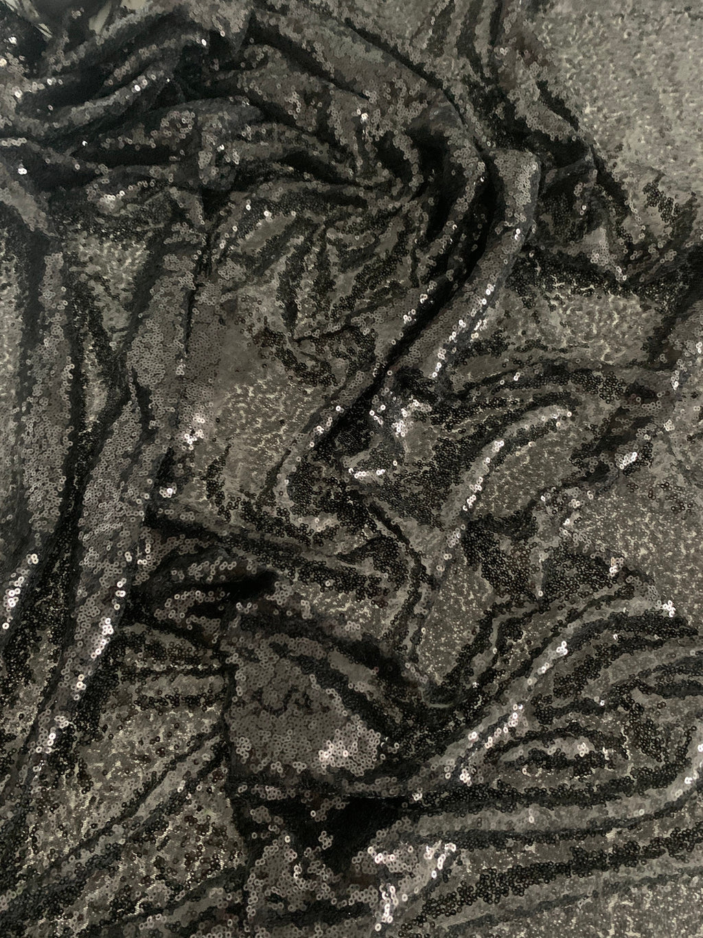 Black Sequins Mesh fabric width 56/57 inches sequins area 48 inches fabric has salvage mesh fabric on both side.