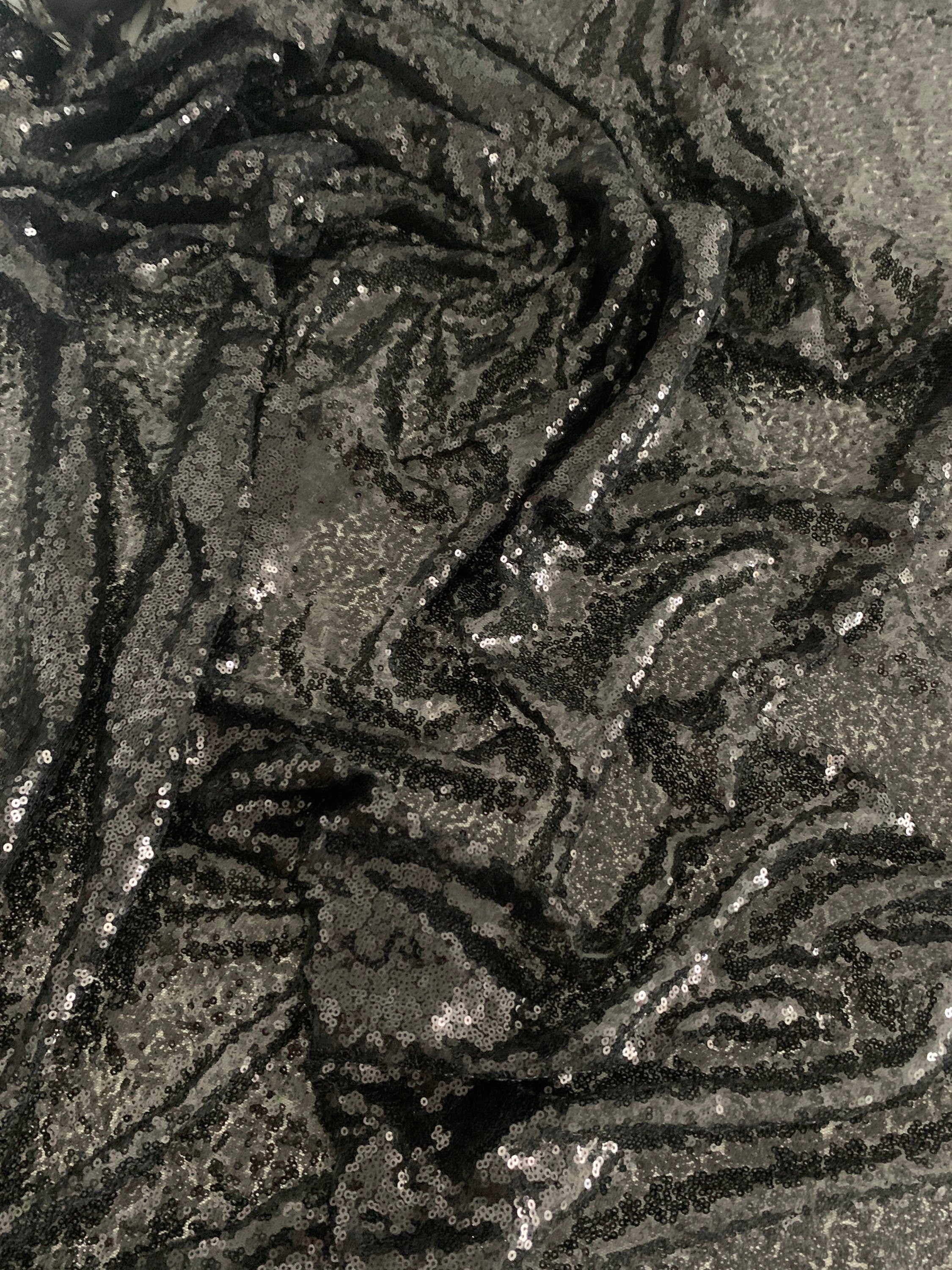 Black Sequins Mesh fabric width 56/57 inches sequins area 48 inches fabric has salvage mesh fabric on both side.