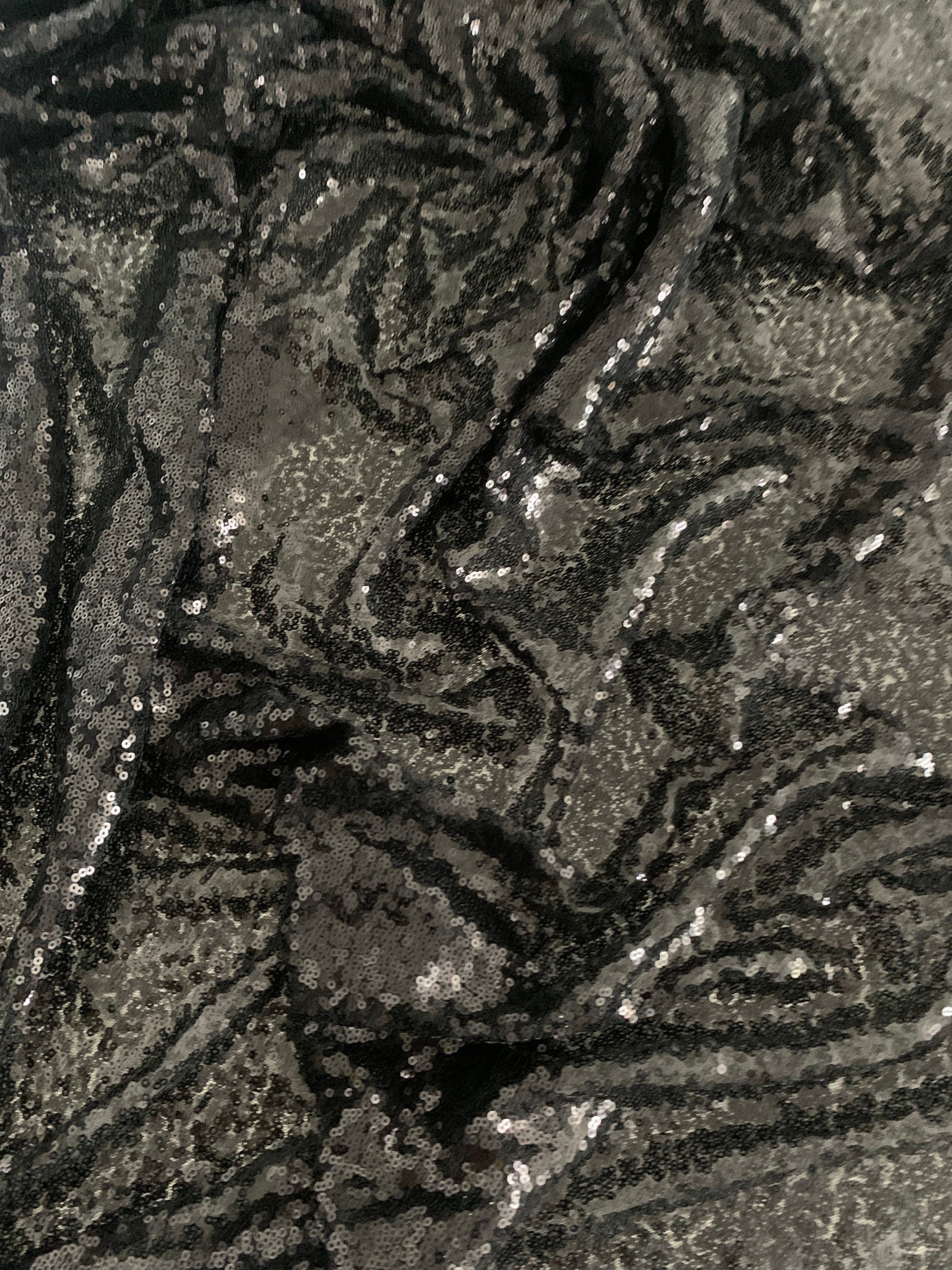Black Sequins Mesh fabric width 56/57 inches sequins area 48 inches fabric has salvage mesh fabric on both side.