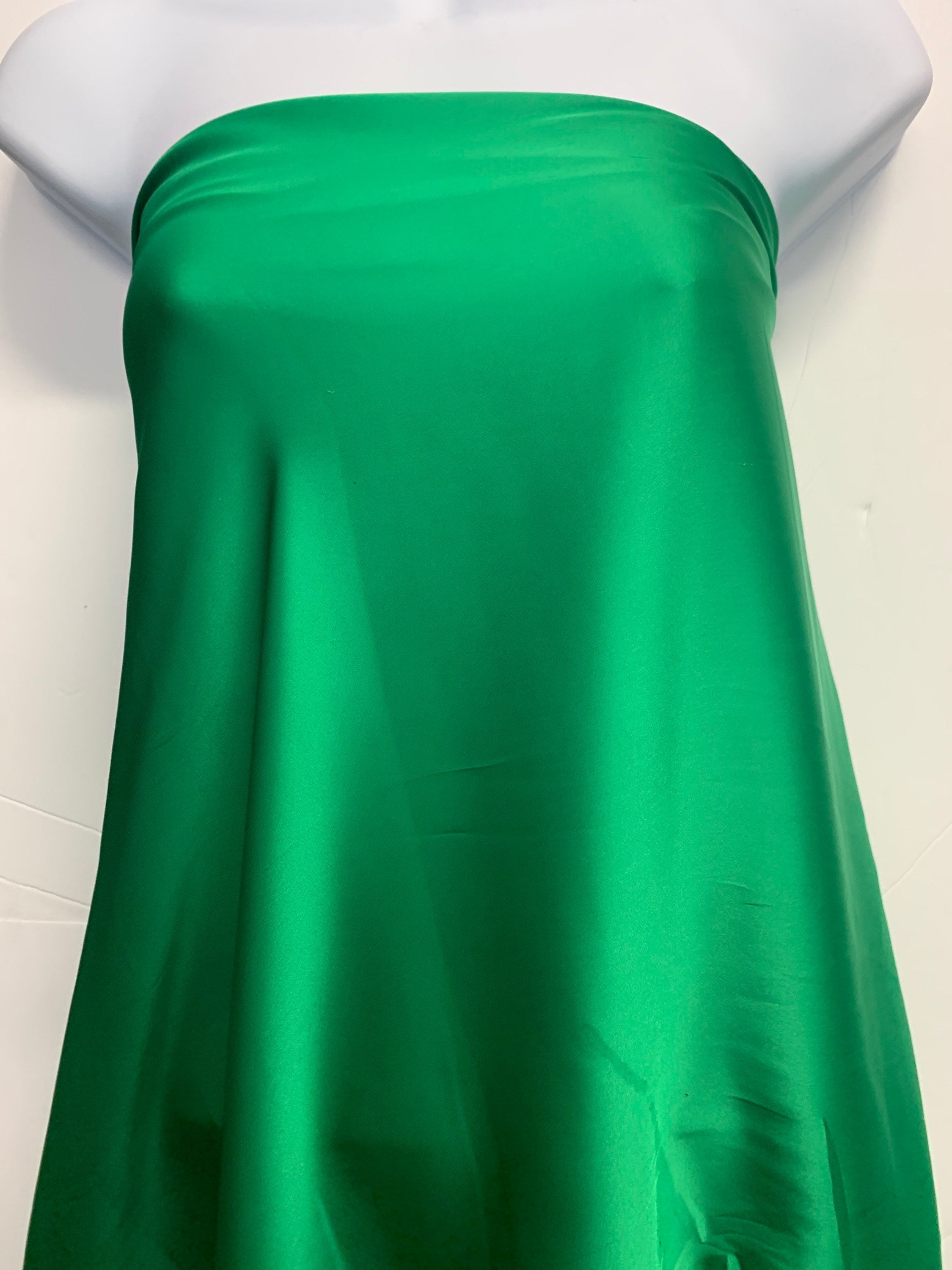 Silky dull soft satin fabric, color Emerald width 59/60 inches 100% polyester. use for blouse, dress and light weight garment and sheer.