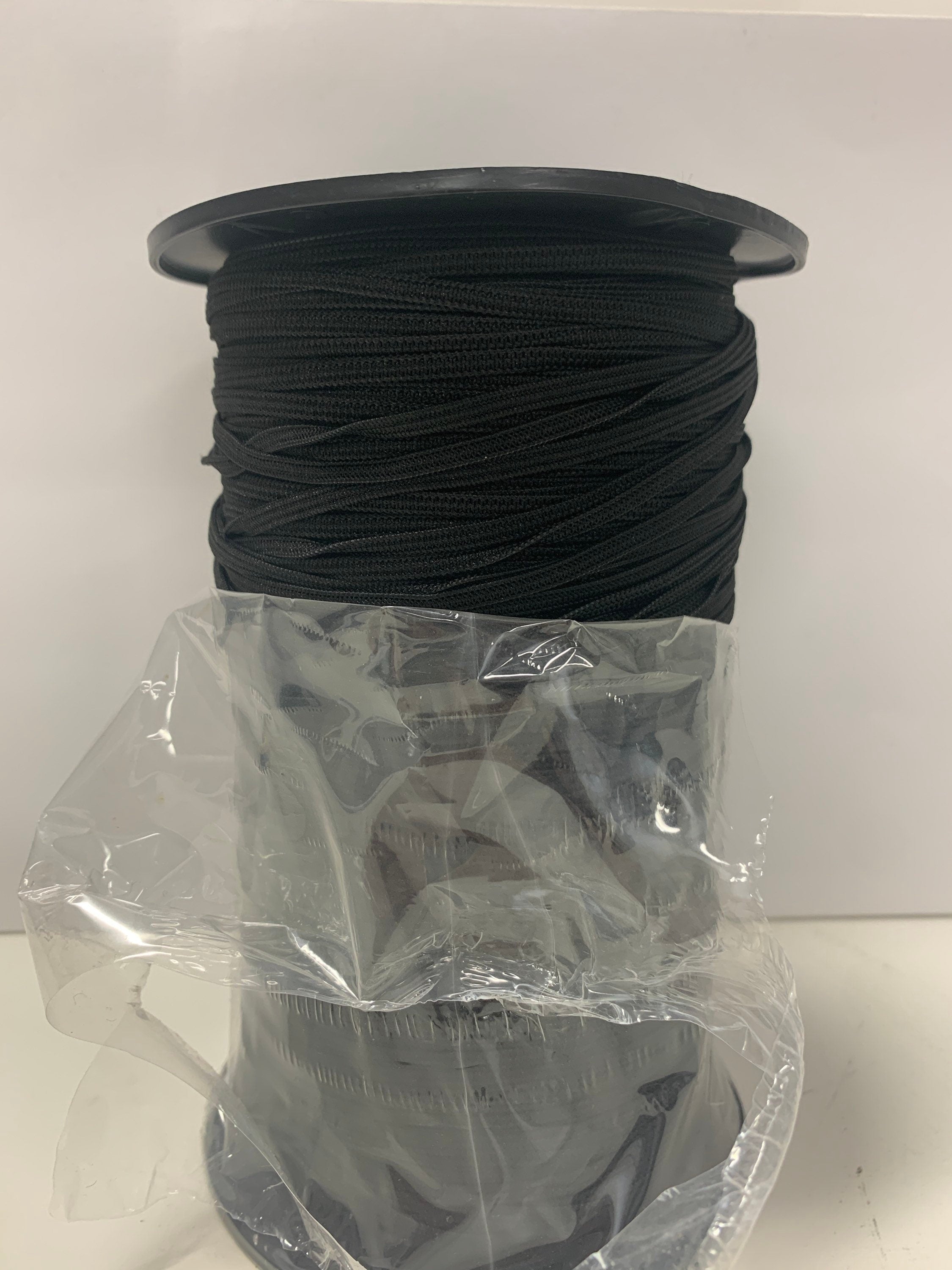 elastic color black width1/8 inch 300 yards per spool. More description , 1/8" Braided elastic string .