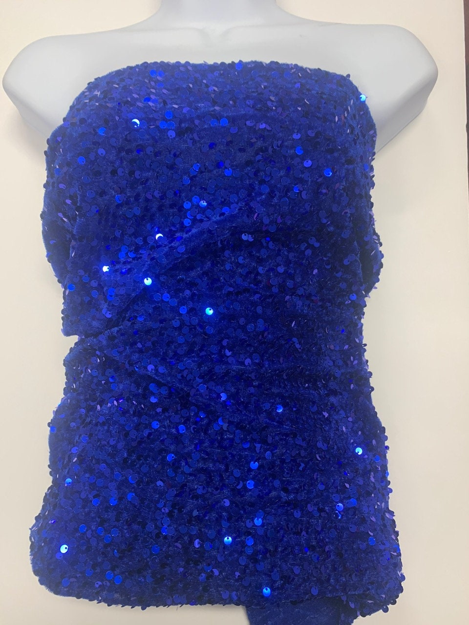 Pane velour sequins fabric. color royal blue, polyester yarn and metallic sewn sequins width is 58/59” with plain salvage of 3” both side