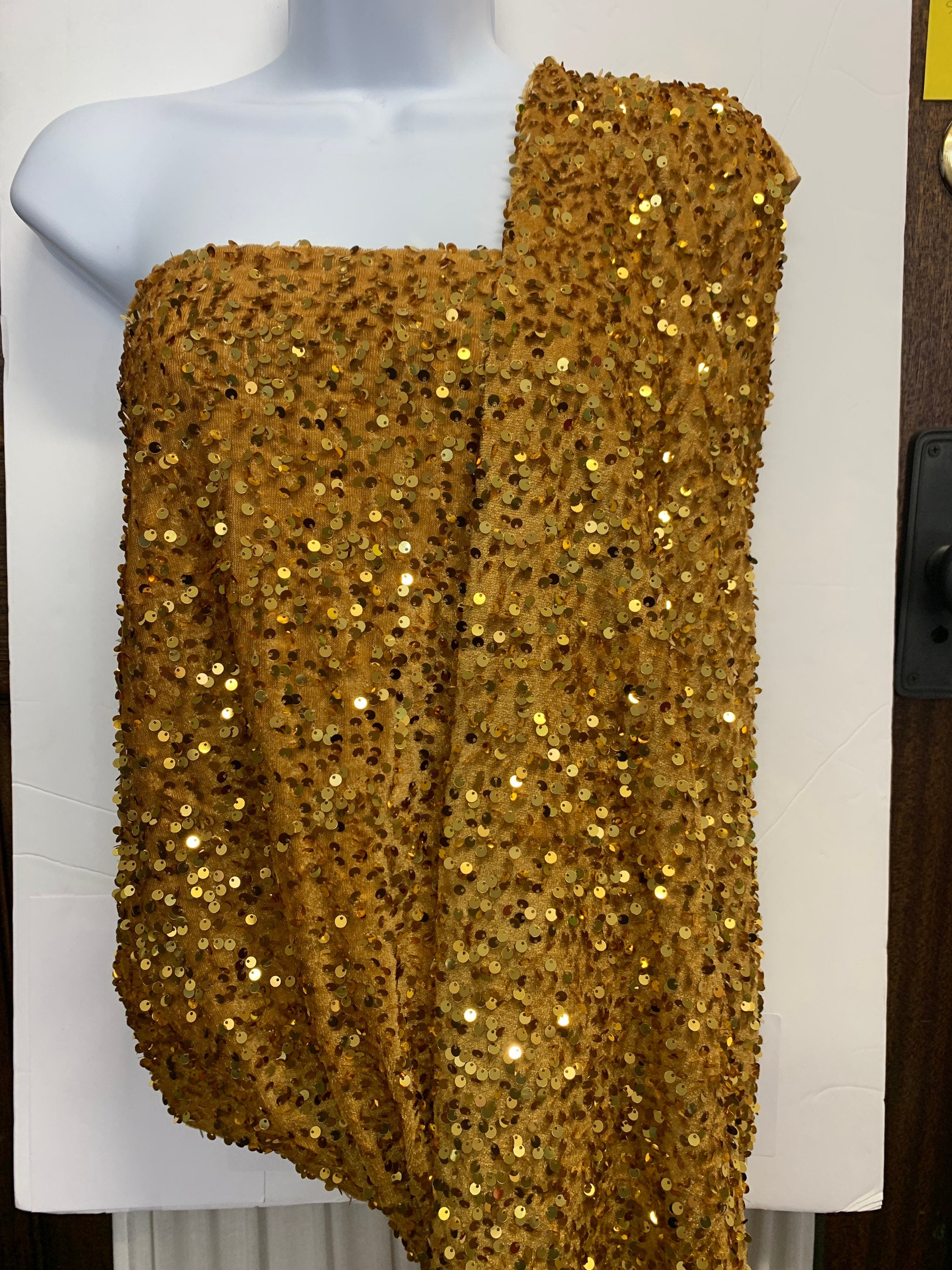 Pane velour sequins fabric, color gold width 59/60" 100% polyester. Sells in 1-yard increments, continuous.