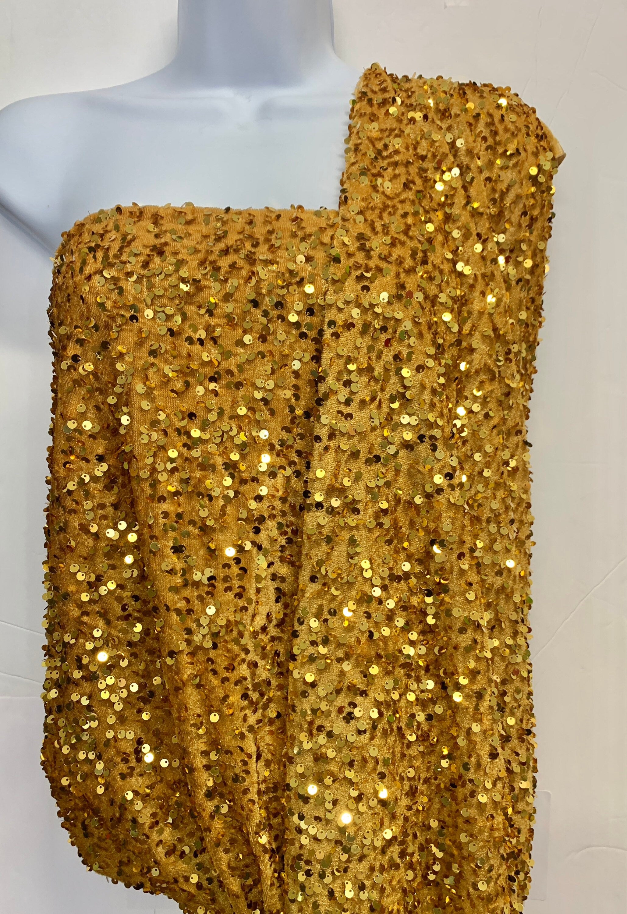 Pane velour sequins fabric, color gold width 59/60" 100% polyester. Sells in 1-yard increments, continuous.