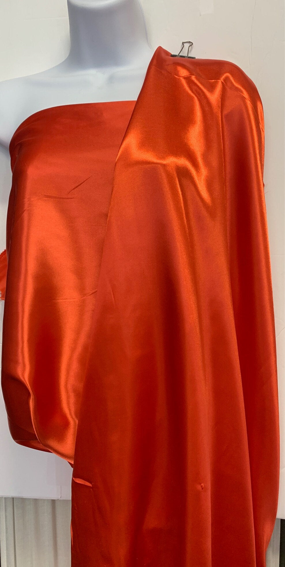 Soft silky satin fabric, width 58/60 inches 100% polyester color Coral known as Charmeuse satin fabric suitable for lingerie and apparel.