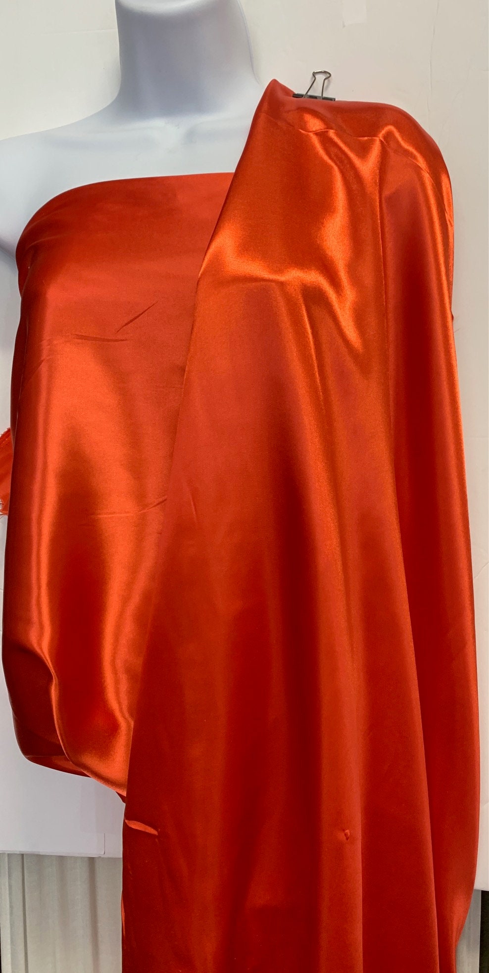 Soft silky satin fabric, width 58/60 inches 100% polyester color Coral known as Charmeuse satin fabric suitable for lingerie and apparel.