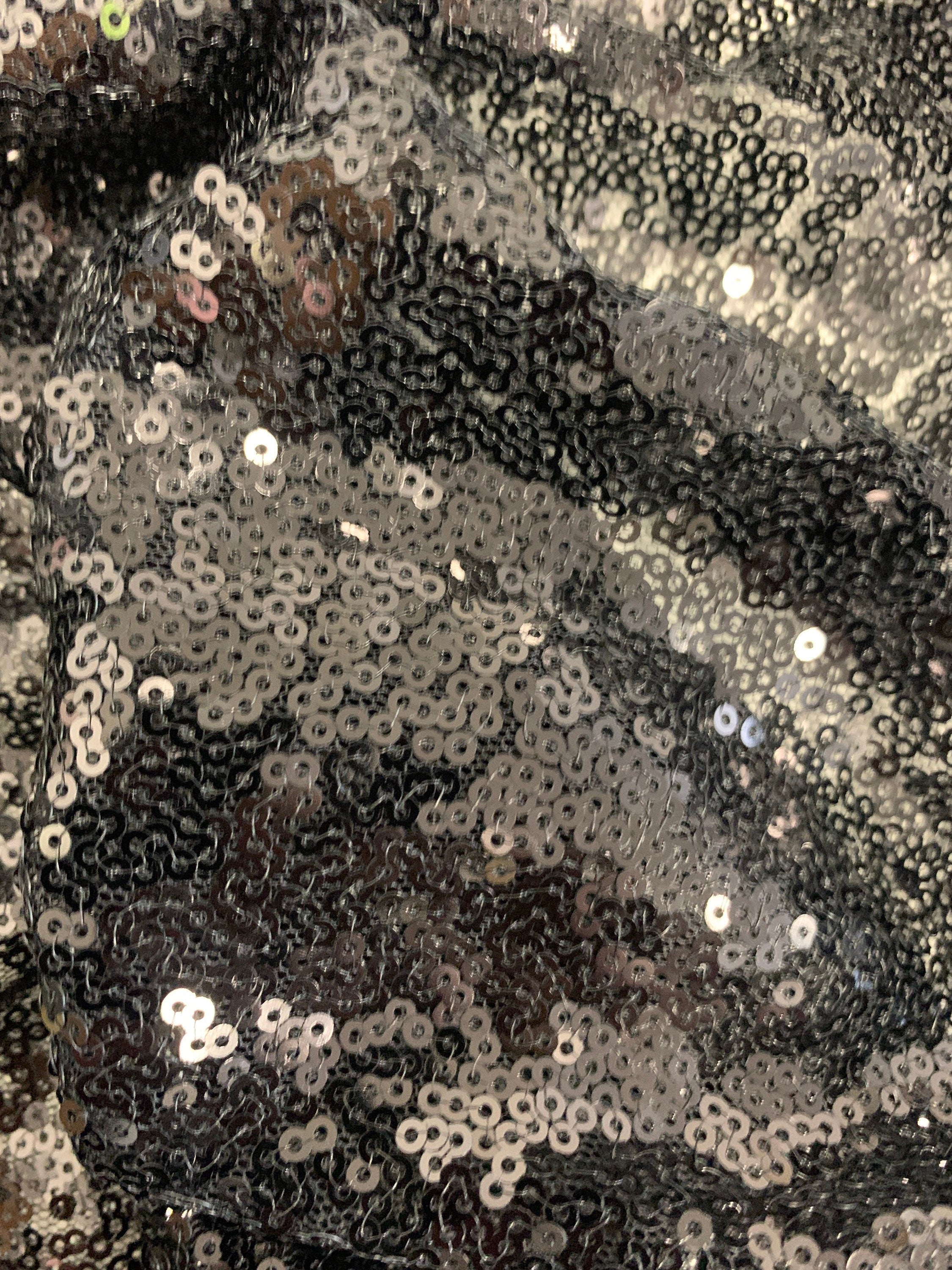 Black Sequins Mesh fabric width 56/57 inches sequins area 48 inches fabric has salvage mesh fabric on both side.