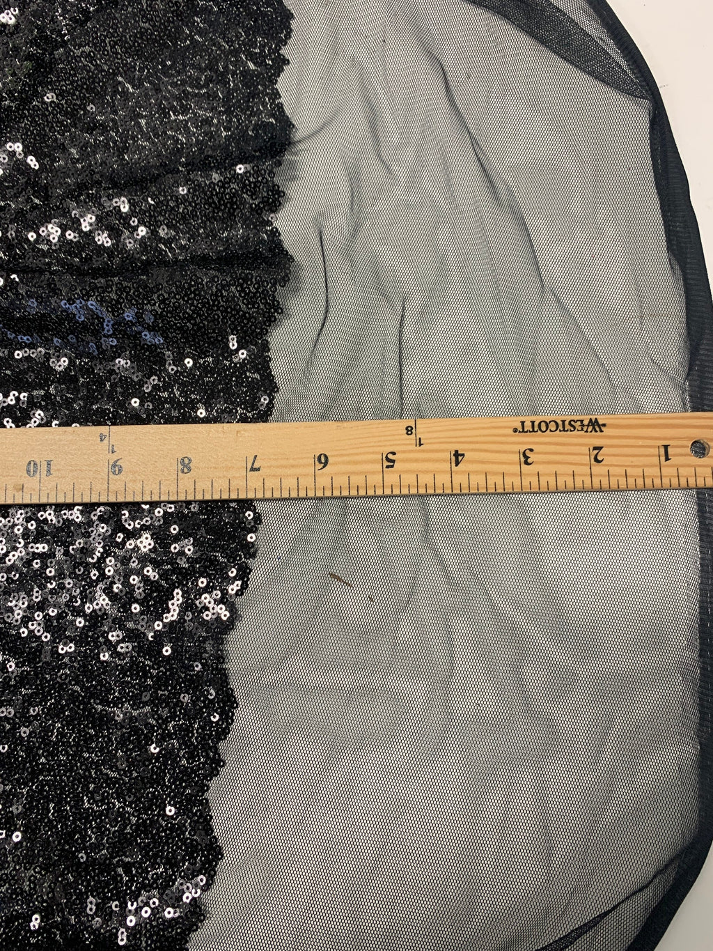 Black Sequins Mesh fabric width 56/57 inches sequins area 48 inches fabric has salvage mesh fabric on both side.