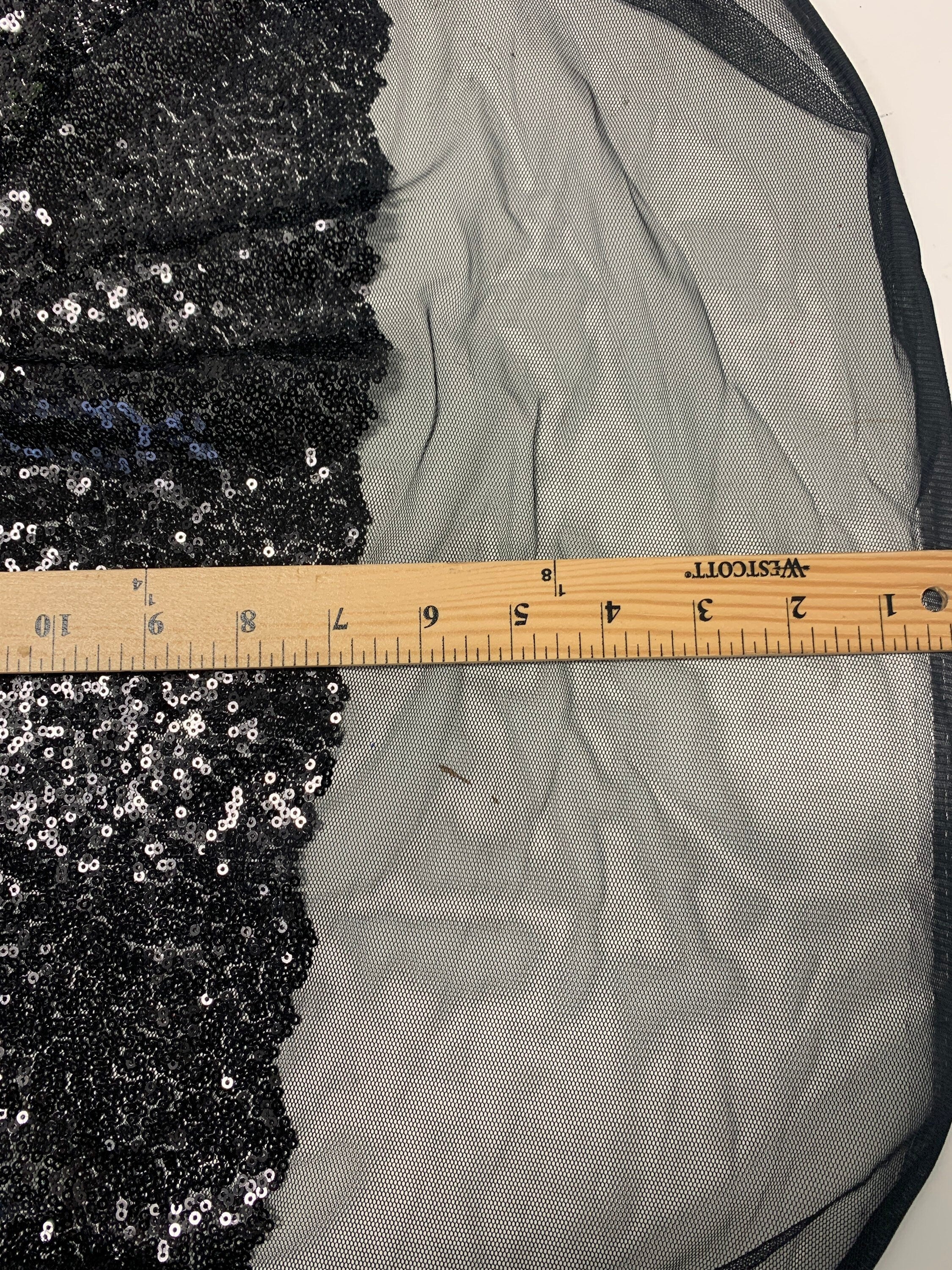 Black Sequins Mesh fabric width 56/57 inches sequins area 48 inches fabric has salvage mesh fabric on both side.