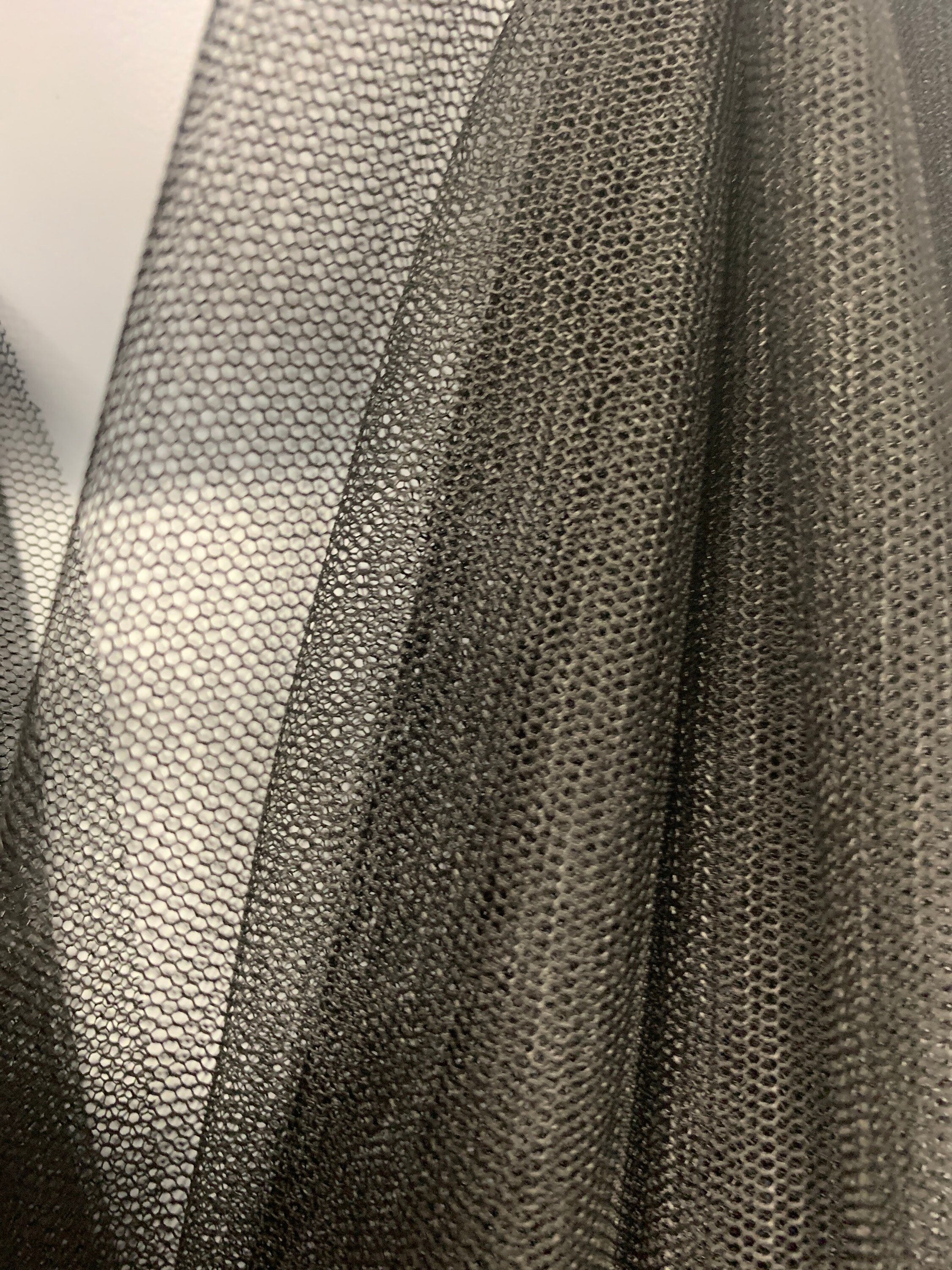 A 2 yards cut Black Mesh Fabric. 100% polyester, width 55 inches. sell by a 2 yards increment continuous.