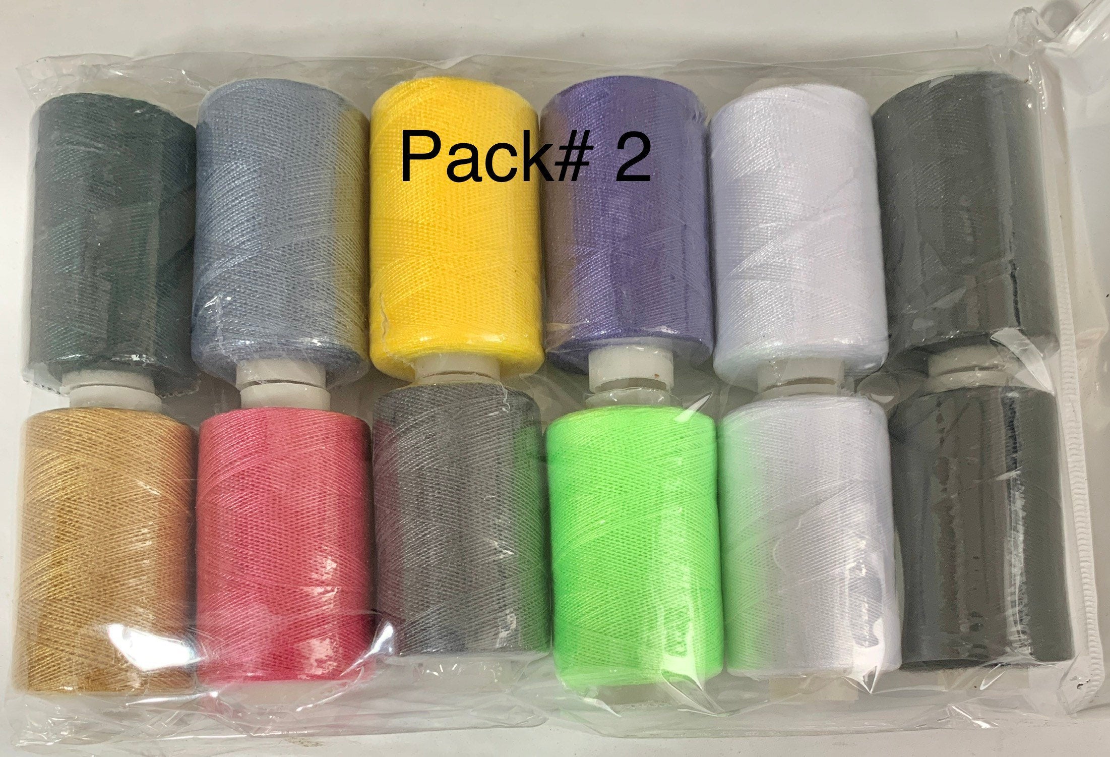 Sewing threads 12 assorted colors per package, each package assortment is different from each other, all packages has 2 black and 2 white.