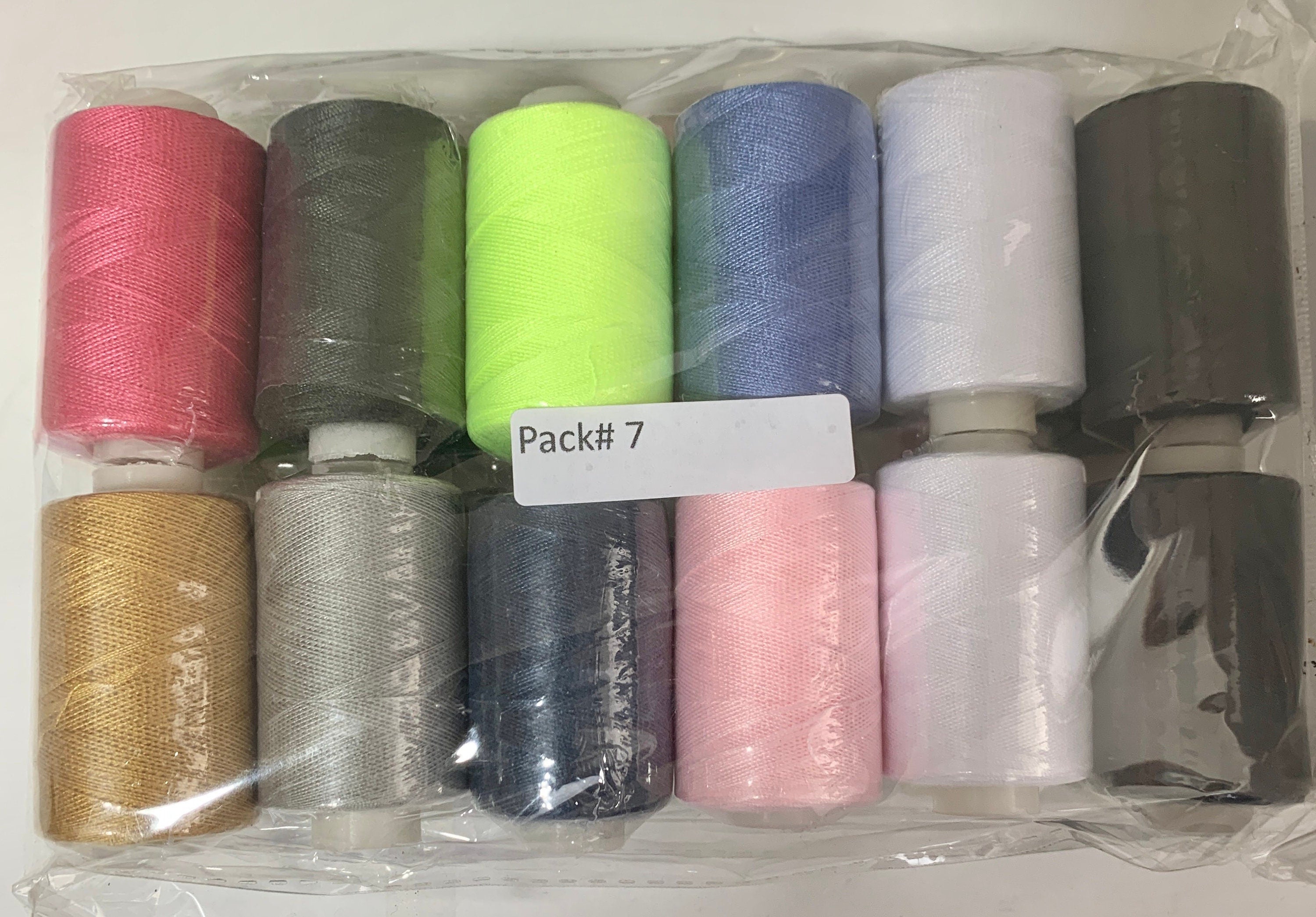 Sewing threads 12 assorted colors per package, each package assortment is different from each other, all packages has 2 black and 2 white.