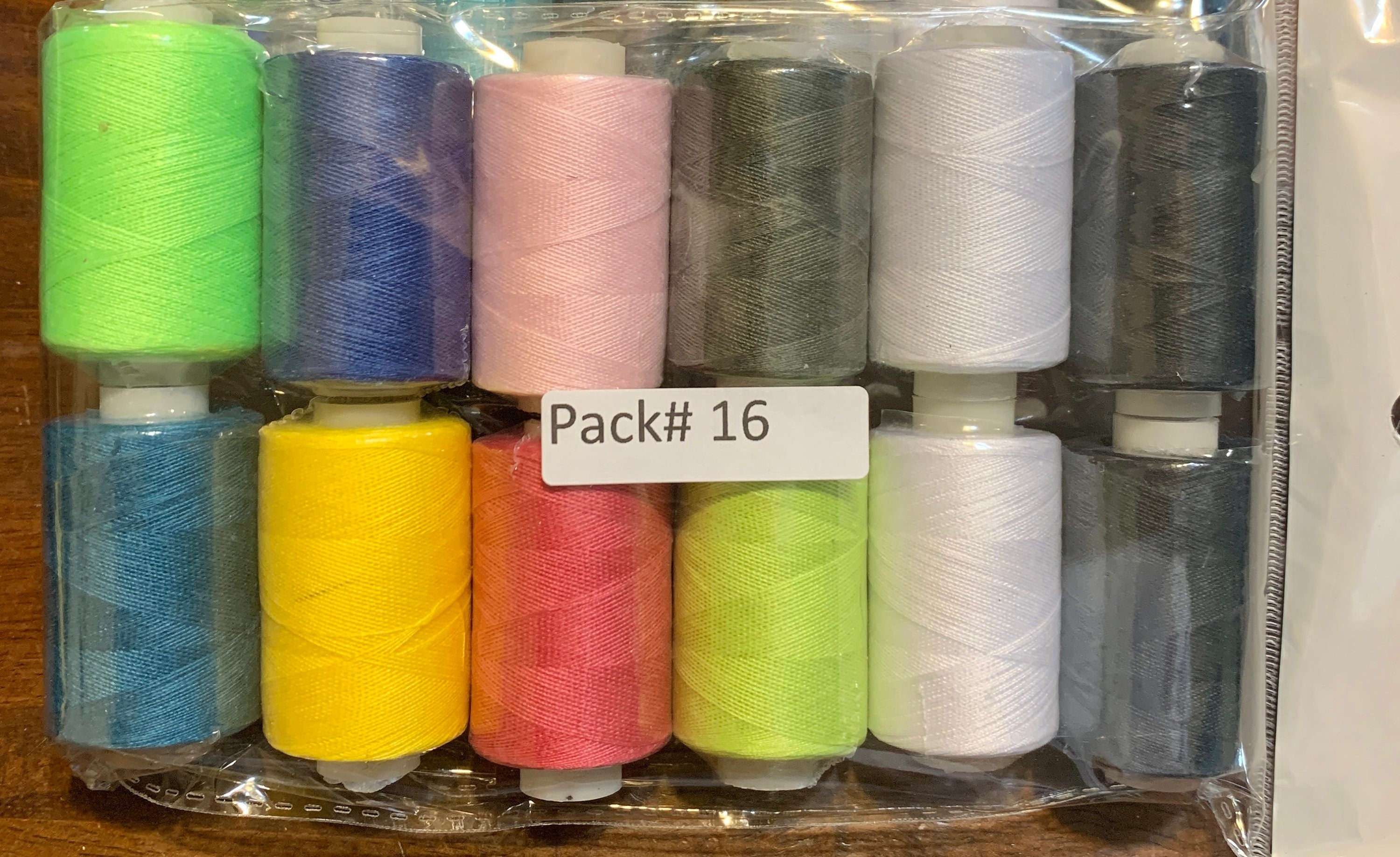 Sewing threads 12 assorted colors per package, each package assortment is different from each other, all packages has 2 black and 2 white.