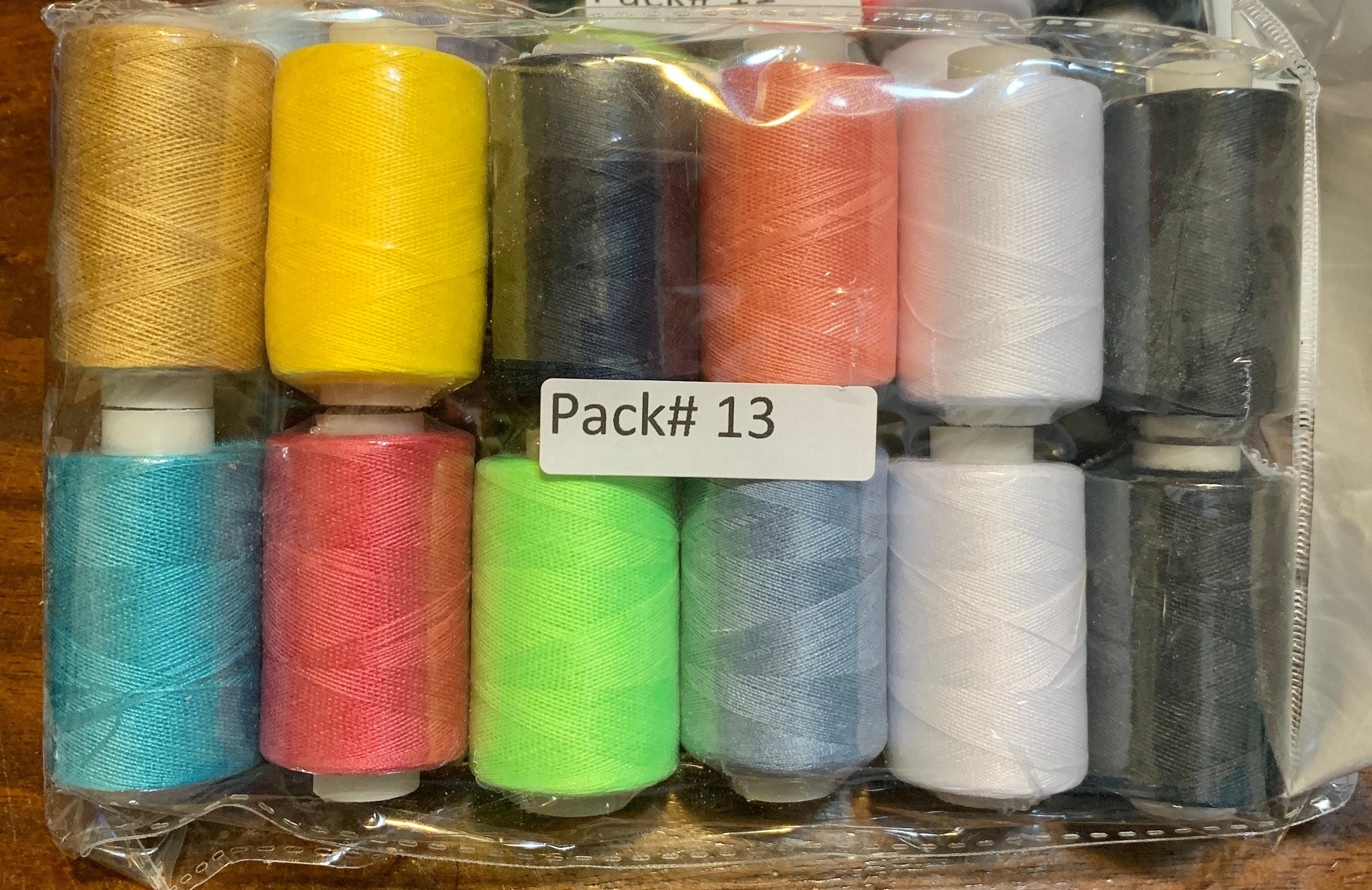 Sewing threads 12 assorted colors per package, each package assortment is different from each other, all packages has 2 black and 2 white.