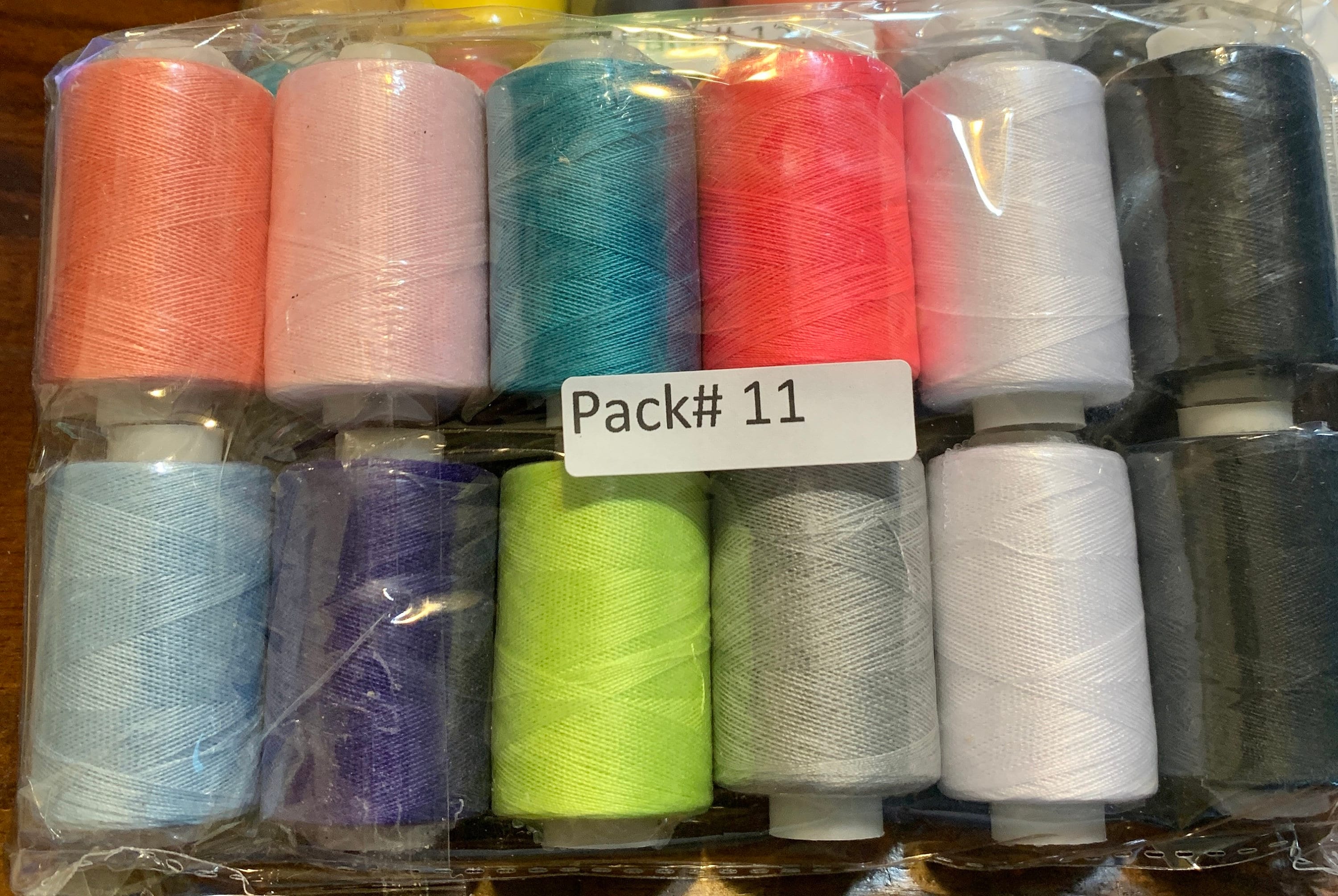 Sewing threads 12 assorted colors per package, each package assortment is different from each other, all packages has 2 black and 2 white.