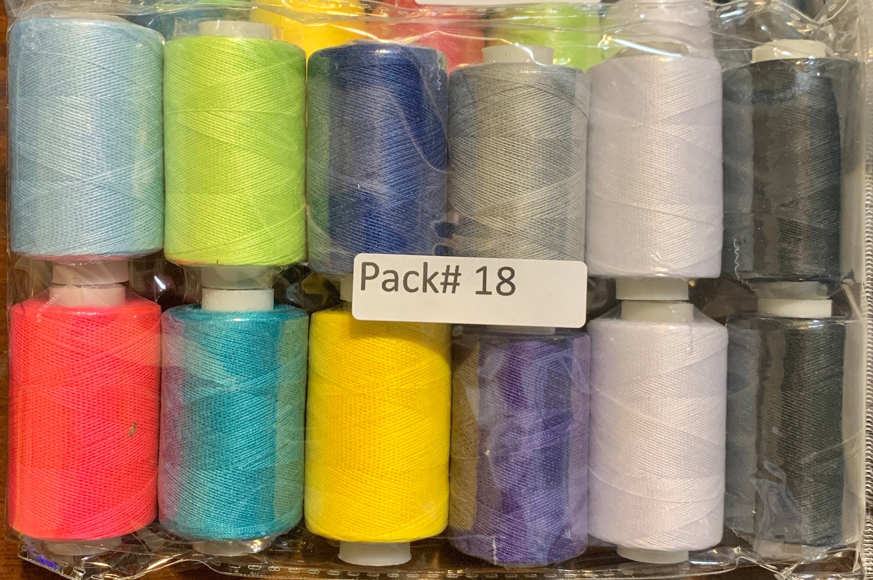 Sewing threads 12 assorted colors per package, each package assortment is different from each other, all packages has 2 black and 2 white.