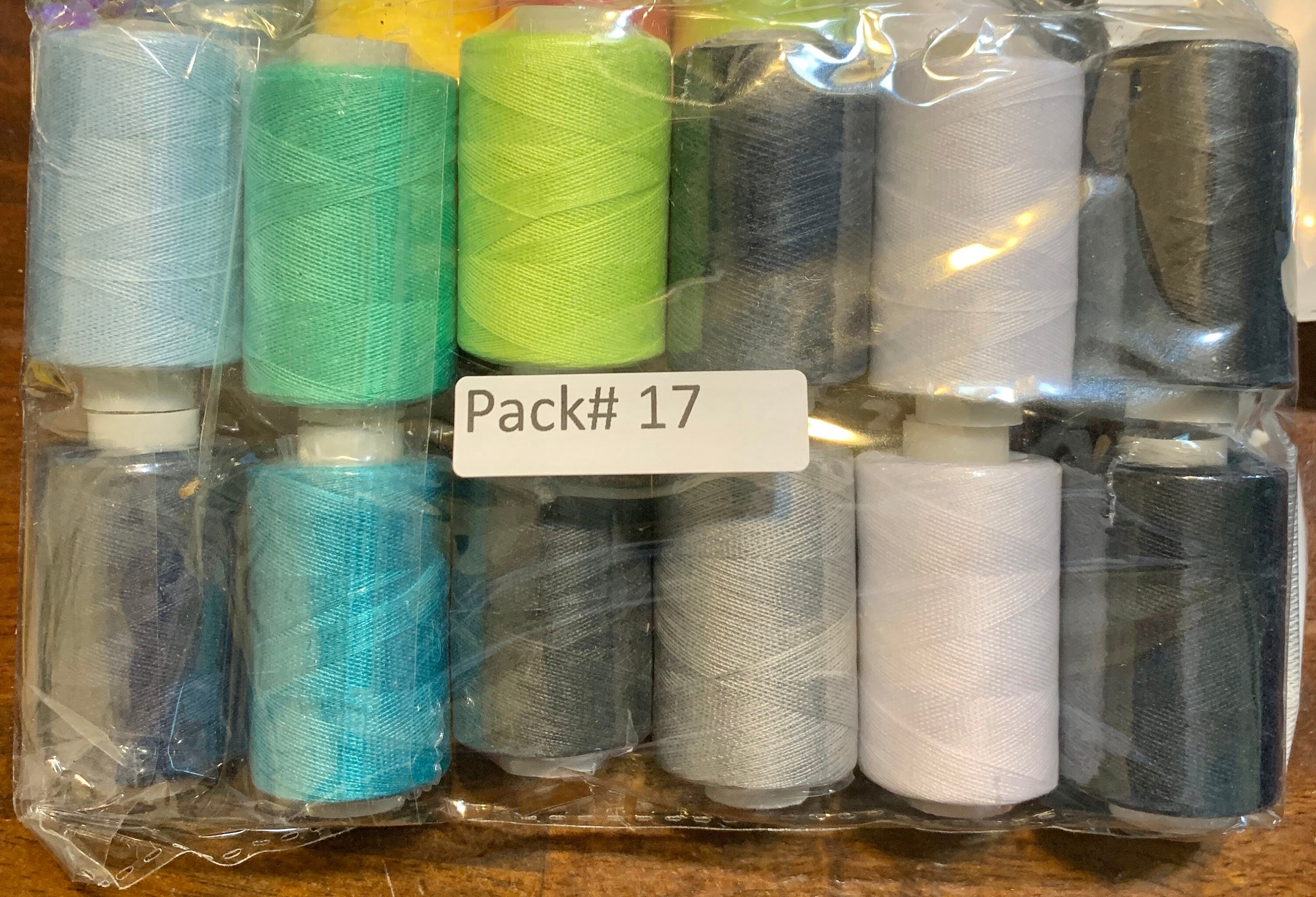 Sewing threads 12 assorted colors per package, each package assortment is different from each other, all packages has 2 black and 2 white.