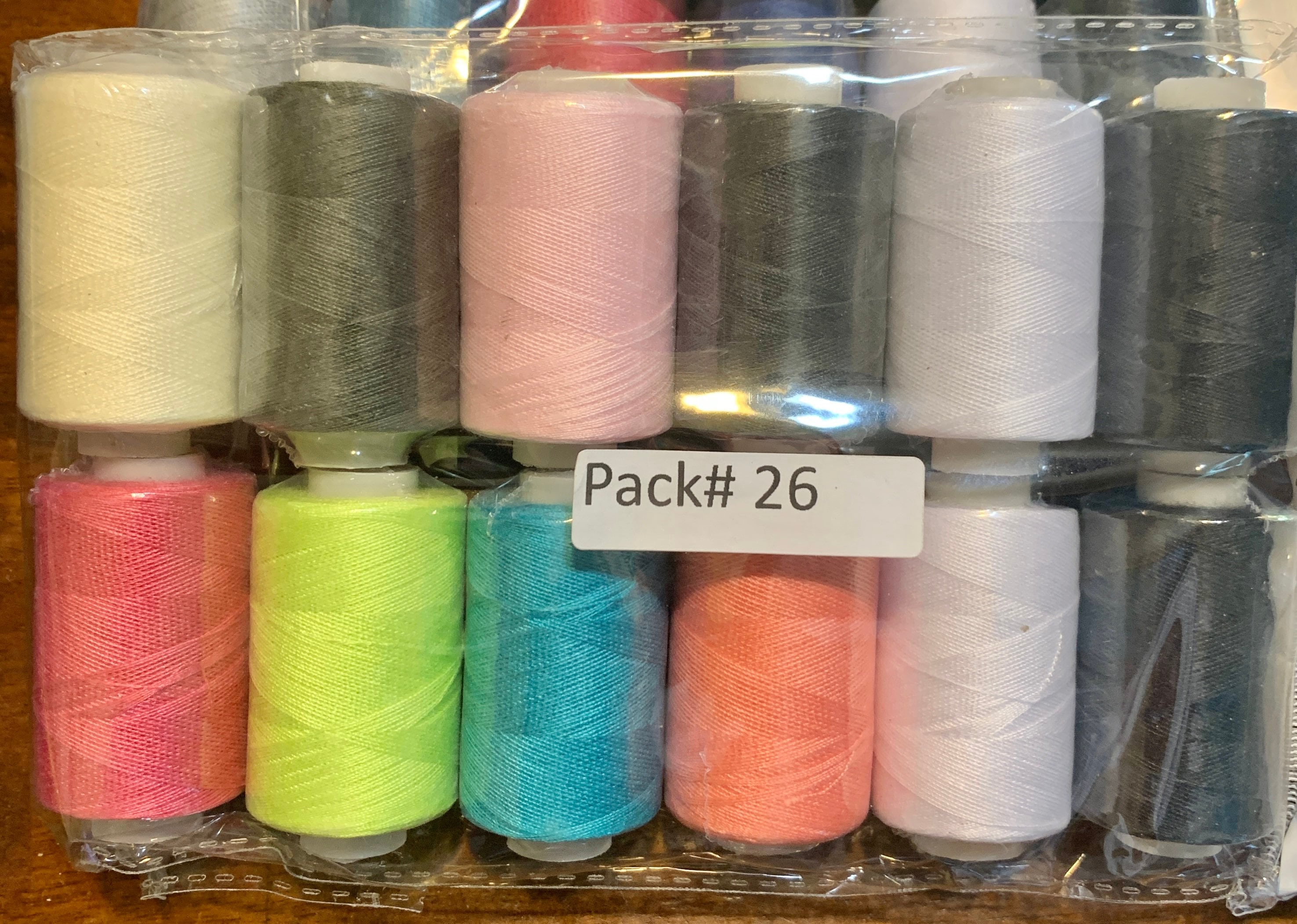 Sewing threads 12 assorted colors per package, each package assortment is different from each other, all packages has 2 black and 2 white.