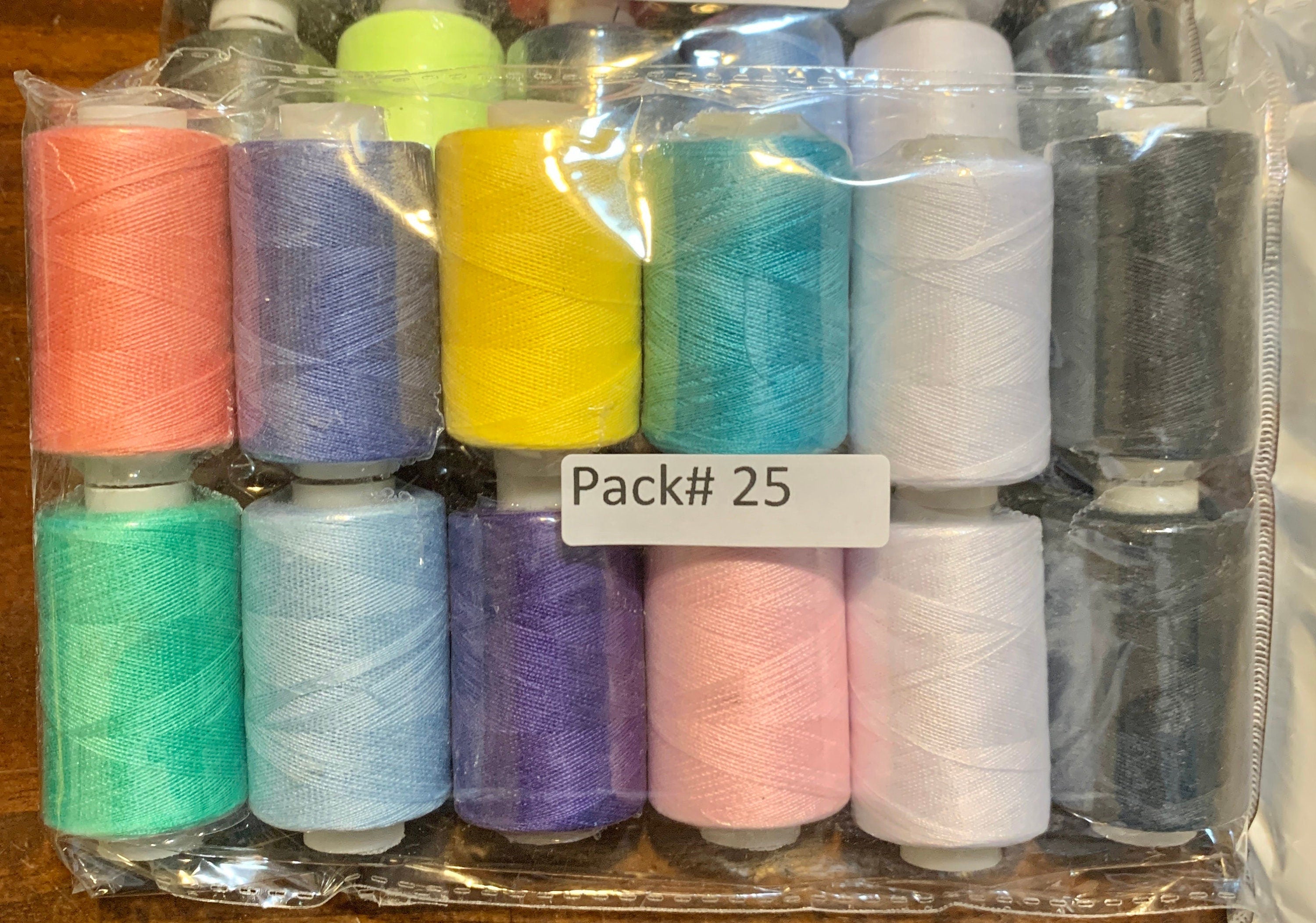 Sewing threads 12 assorted colors per package, each package assortment is different from each other, all packages has 2 black and 2 white.