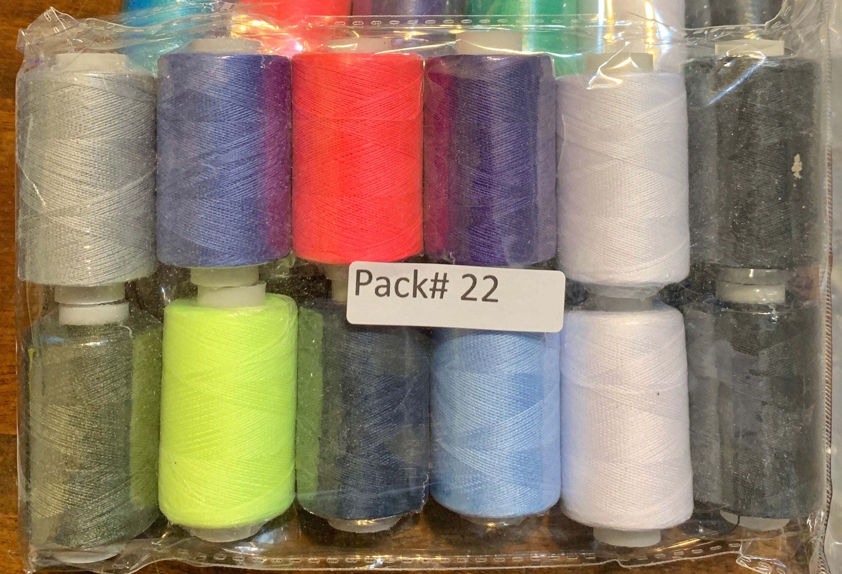 Sewing threads 12 assorted colors per package, each package assortment is different from each other, all packages has 2 black and 2 white.