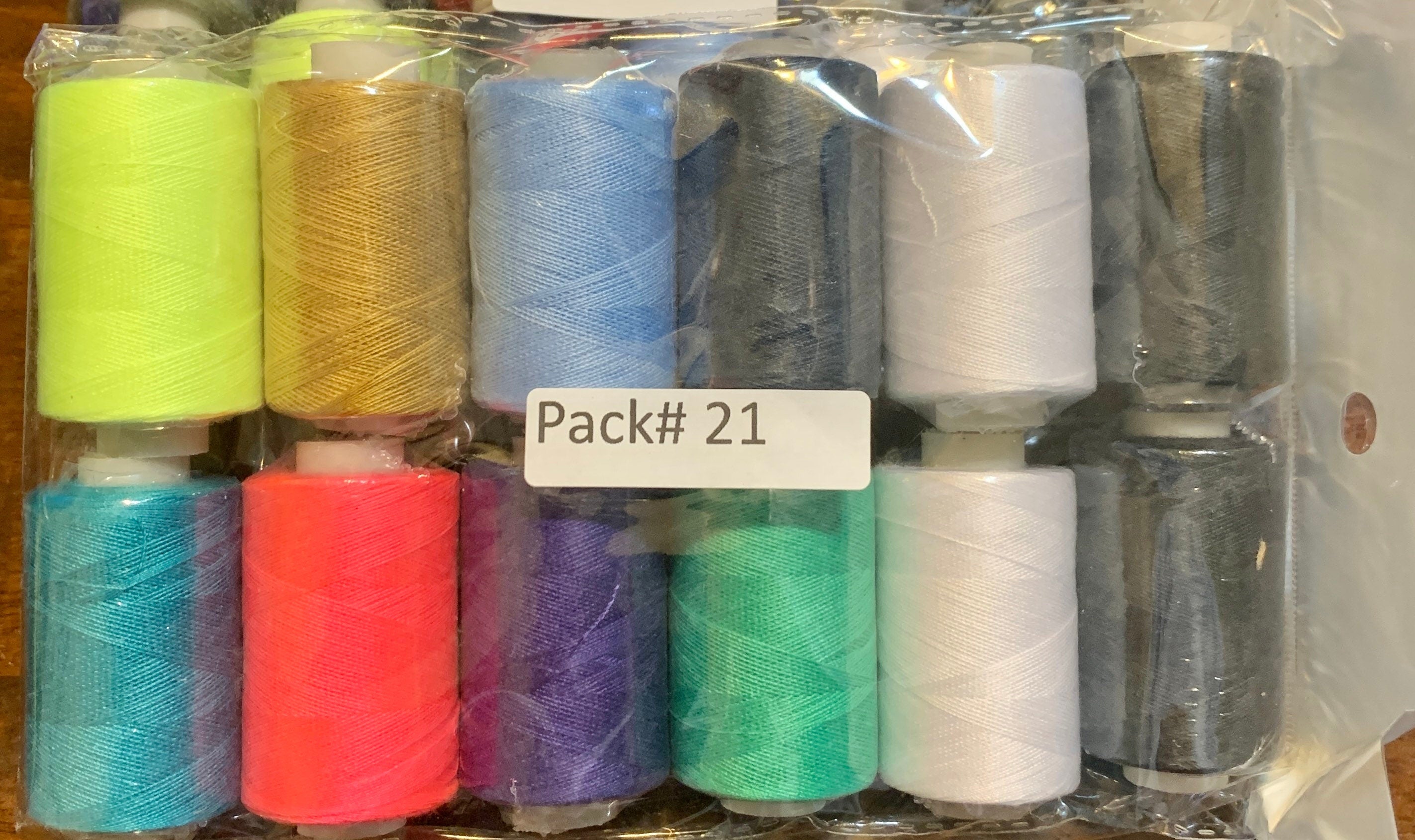 Sewing threads 12 assorted colors per package, each package assortment is different from each other, all packages has 2 black and 2 white.