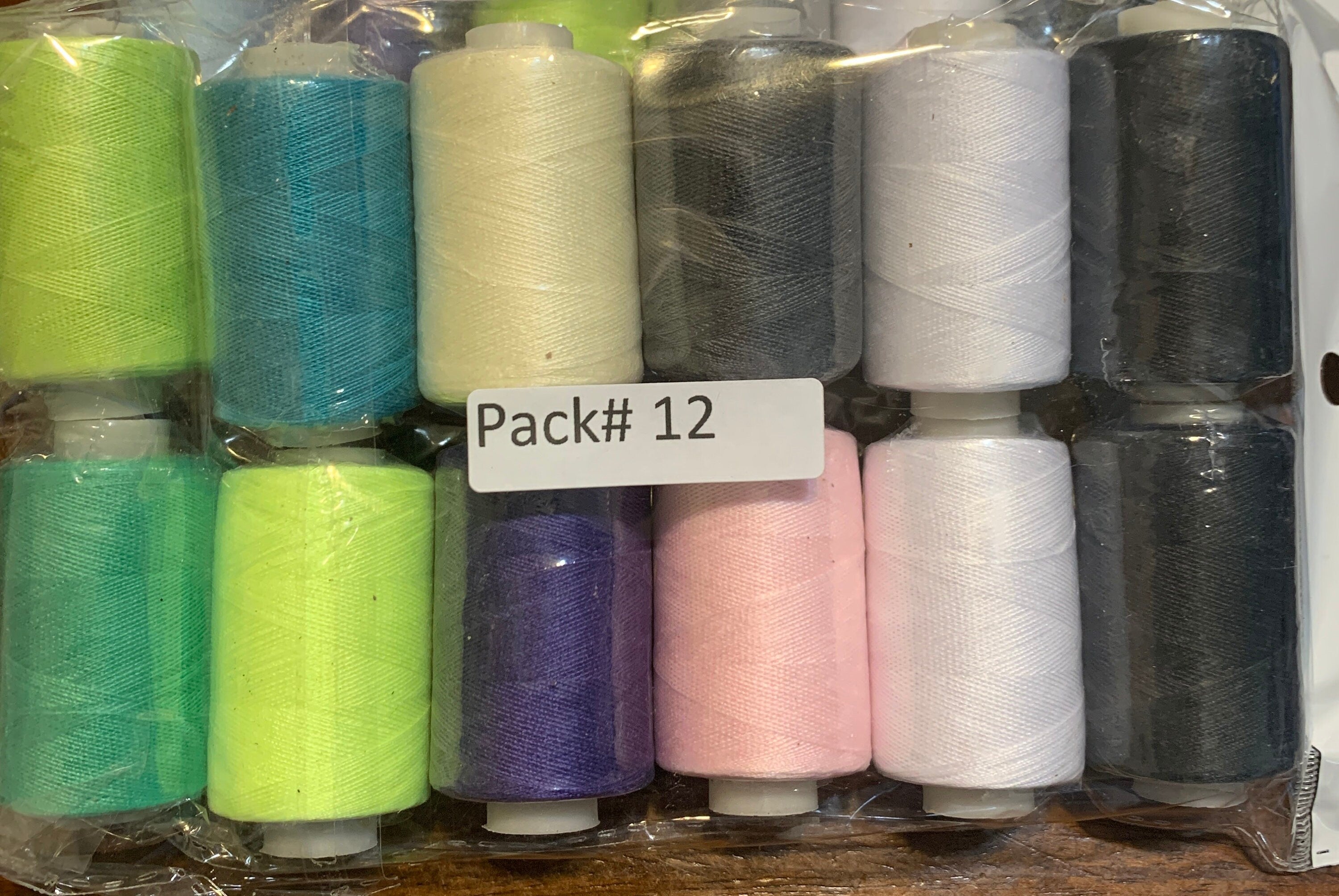 Sewing threads 12 assorted colors per package, each package assortment is different from each other, all packages has 2 black and 2 white.