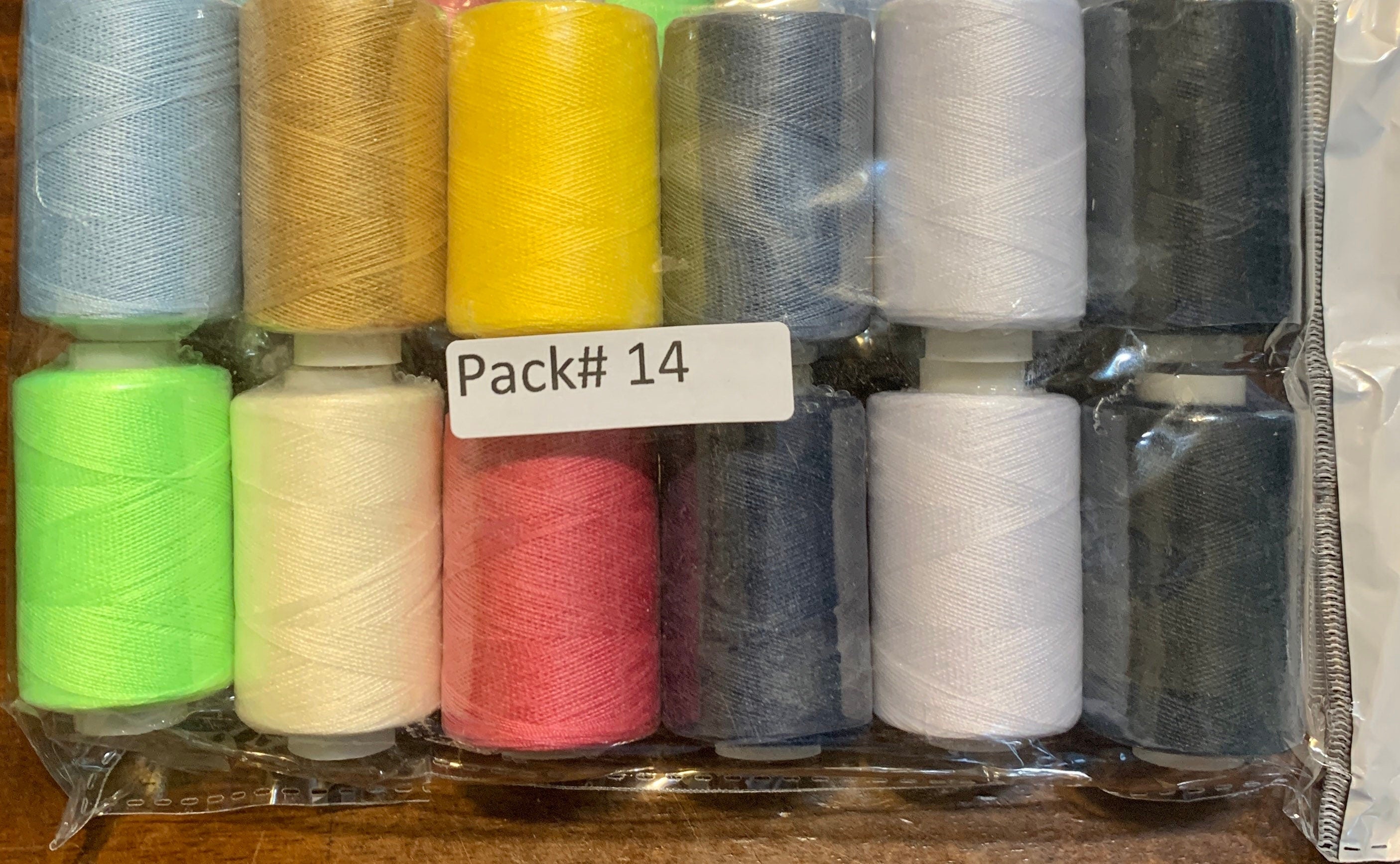 Sewing threads 12 assorted colors per package, each package assortment is different from each other, all packages has 2 black and 2 white.