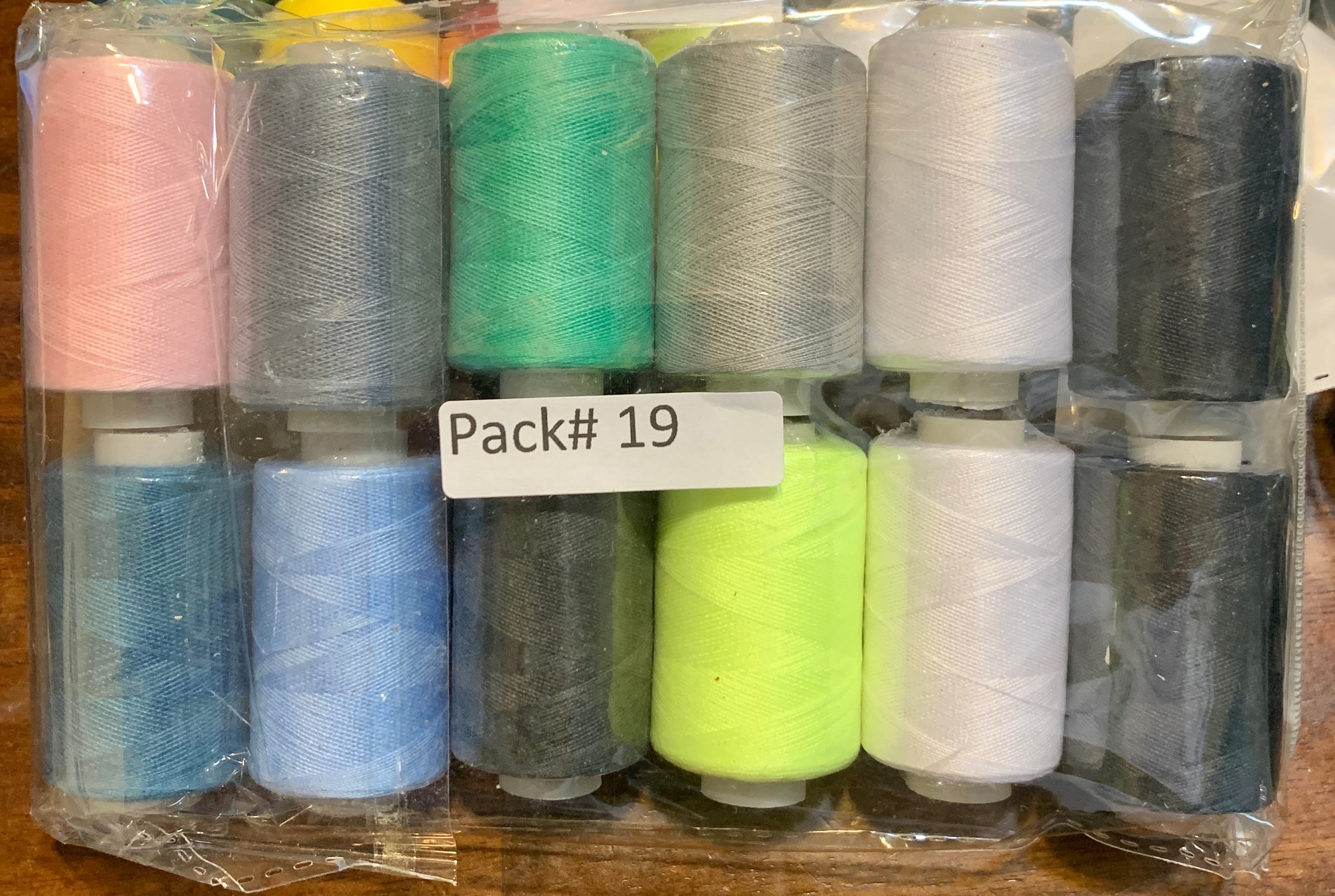 Sewing threads 12 assorted colors per package, each package assortment is different from each other, all packages has 2 black and 2 white.