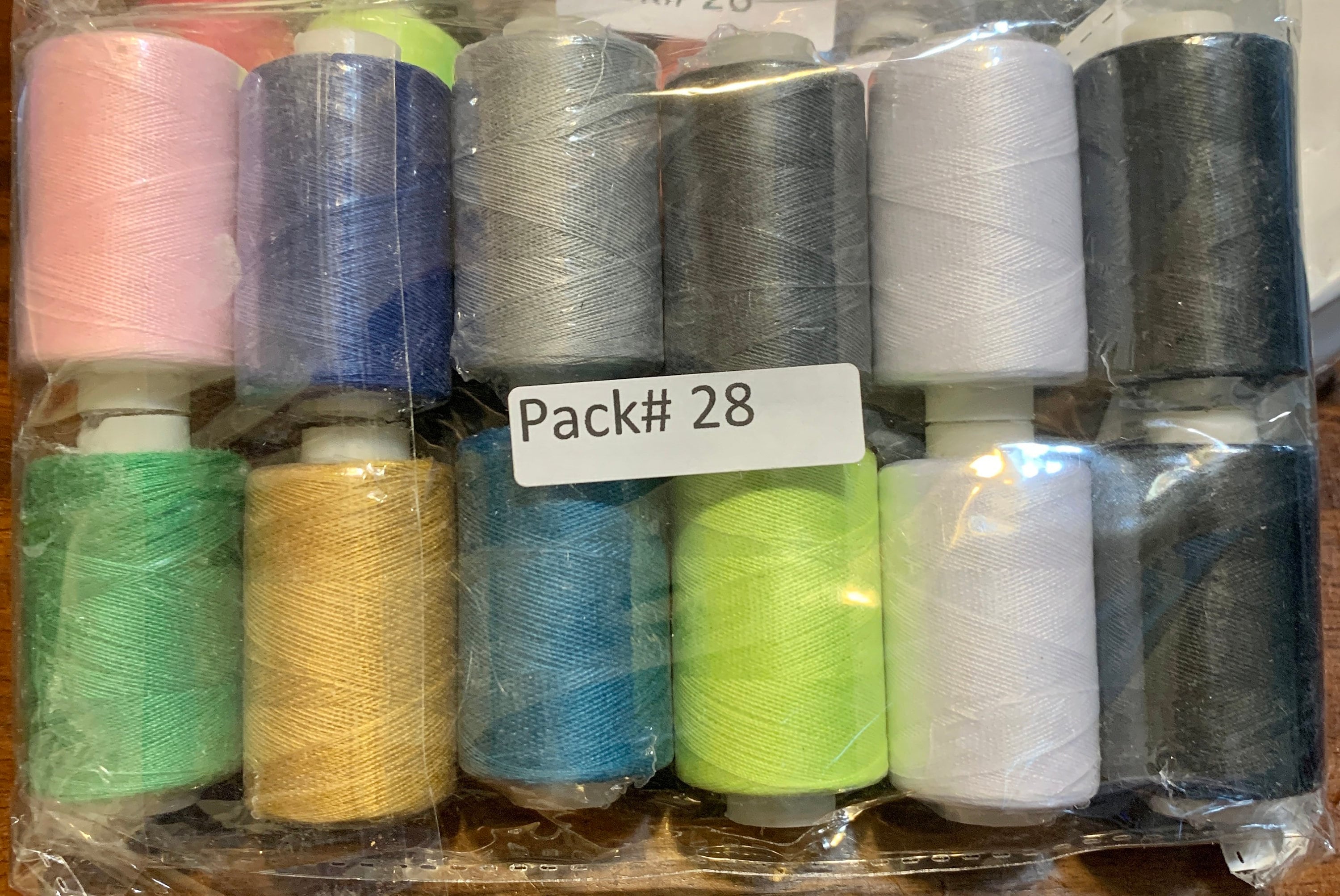 Sewing threads 12 assorted colors per package, each package assortment is different from each other, all packages has 2 black and 2 white.