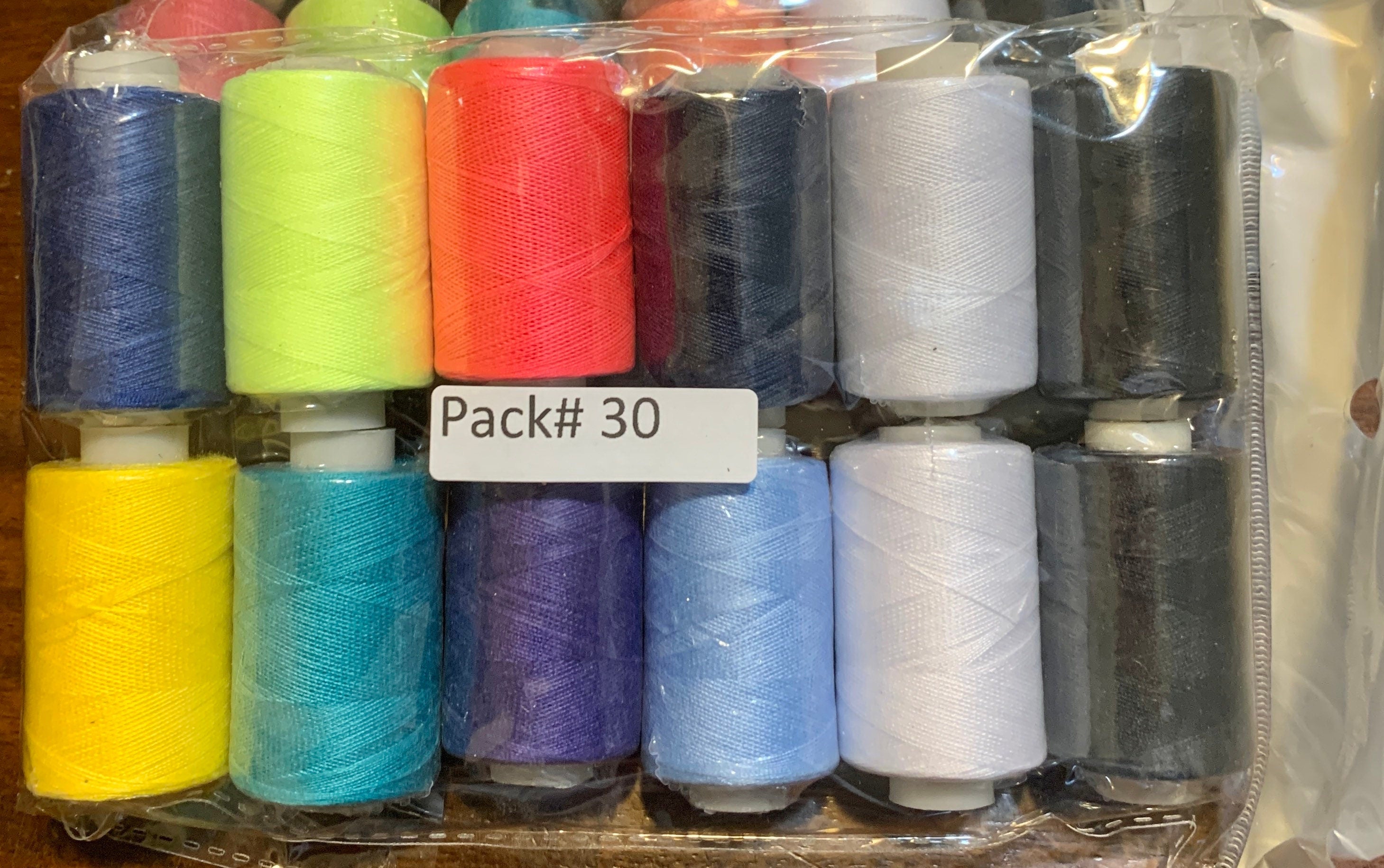 Sewing threads 12 assorted colors per package, each package assortment is different from each other, all packages has 2 black and 2 white.