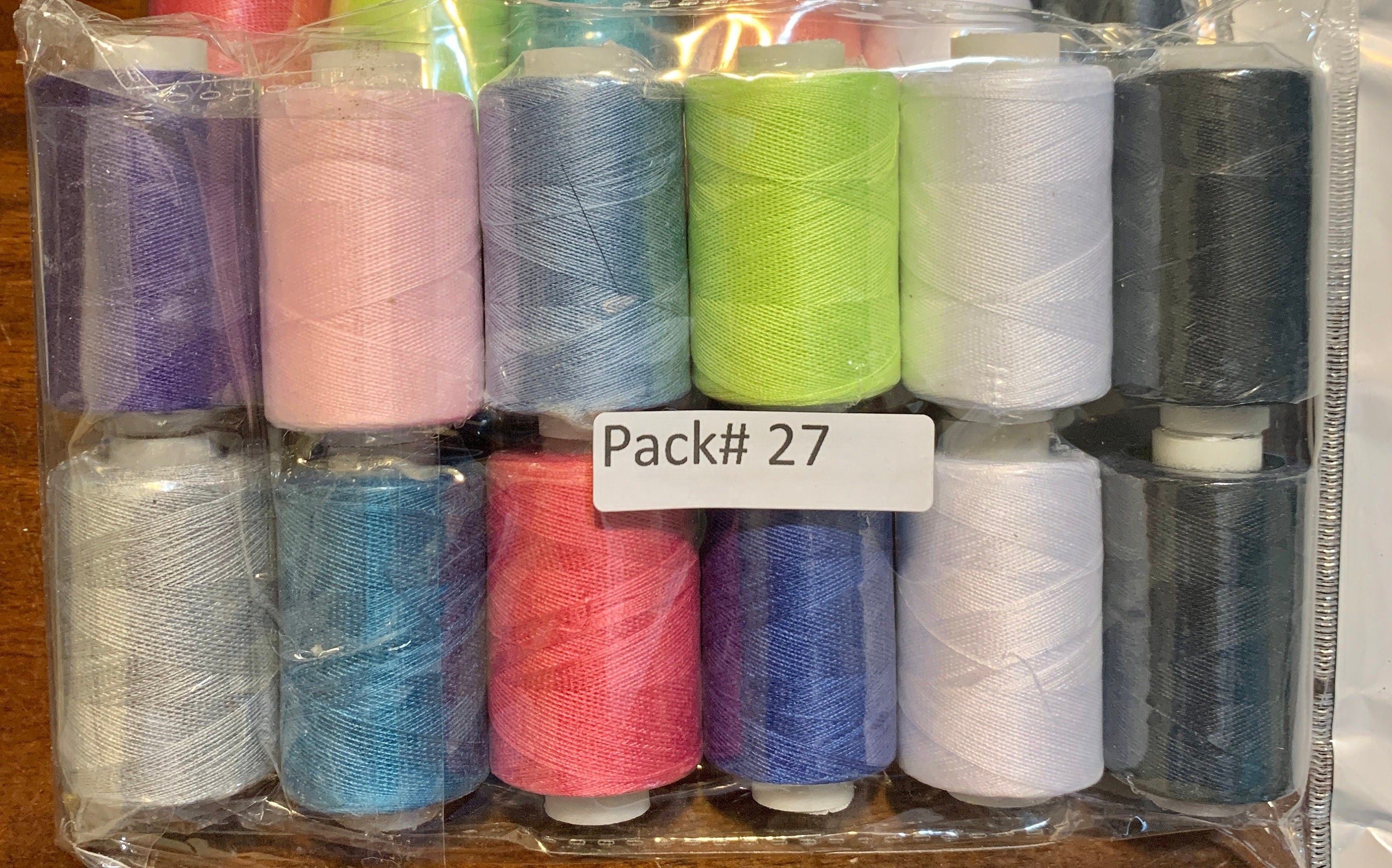 Sewing threads 12 assorted colors per package, each package assortment is different from each other, all packages has 2 black and 2 white.