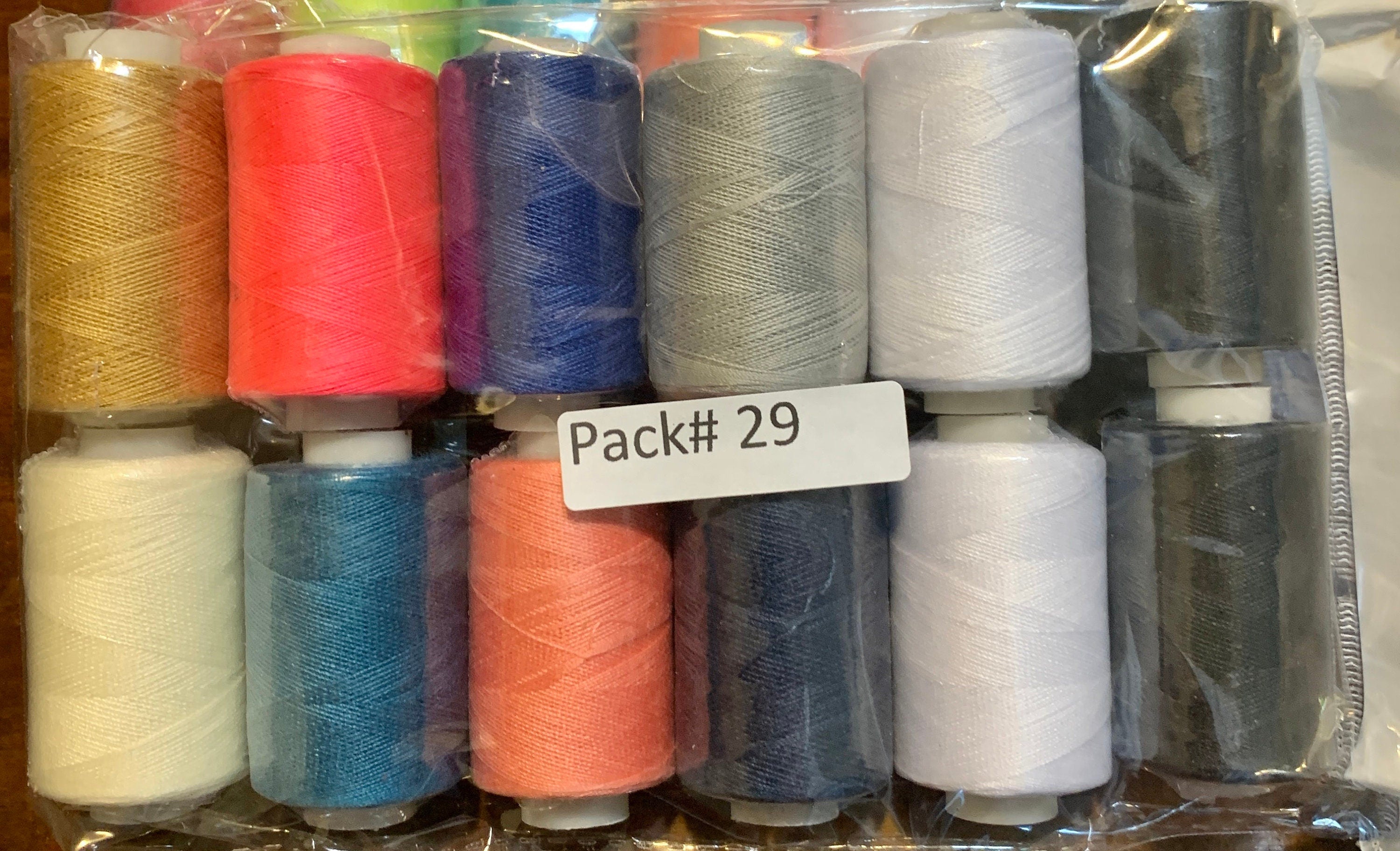 Sewing threads 12 assorted colors per package, each package assortment is different from each other, all packages has 2 black and 2 white.