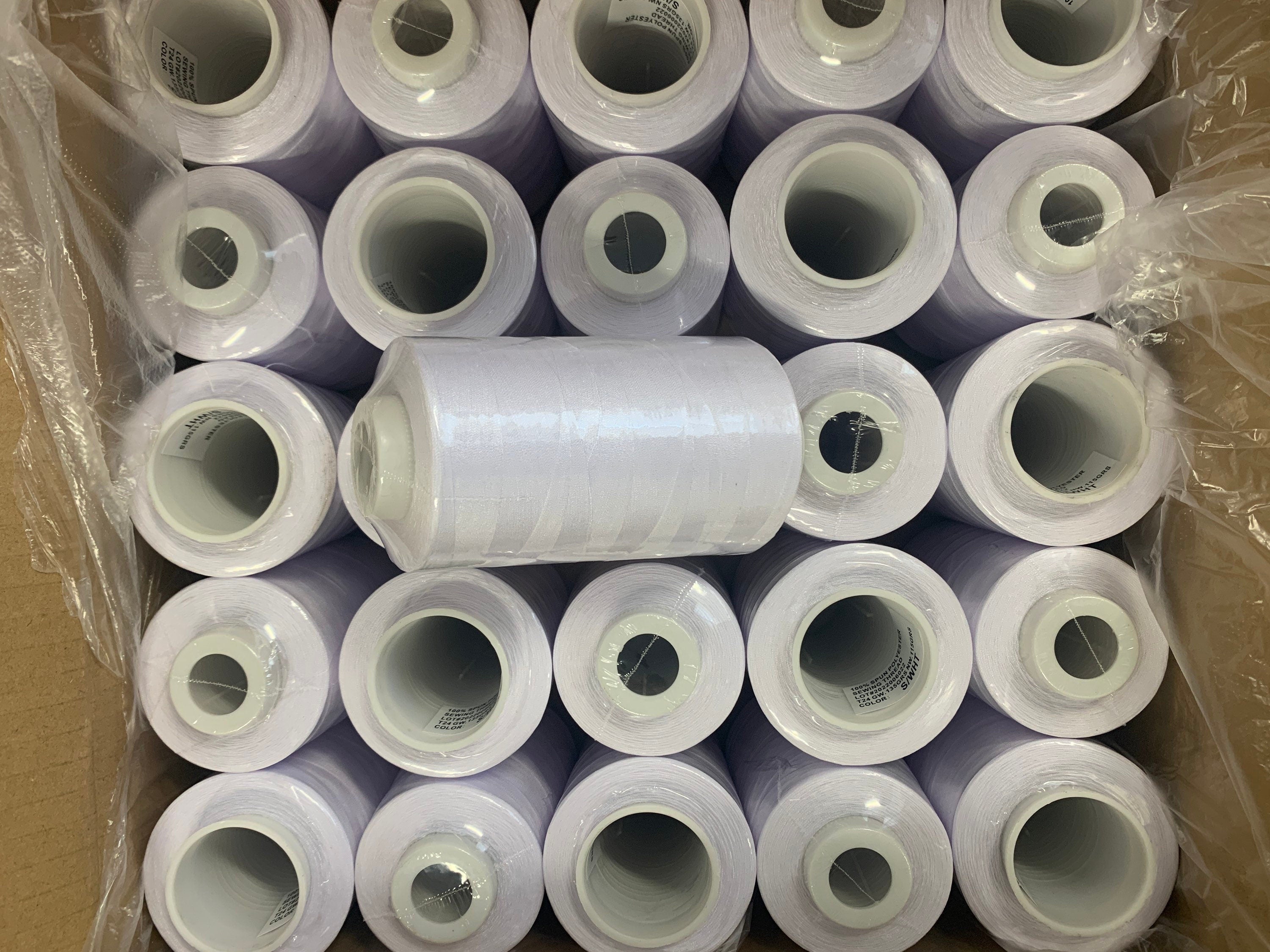 White sewing threads, polyester 130 gram per cone, 3500 yards per cone, wrap in clear cover for daily sewing. thread size 24T