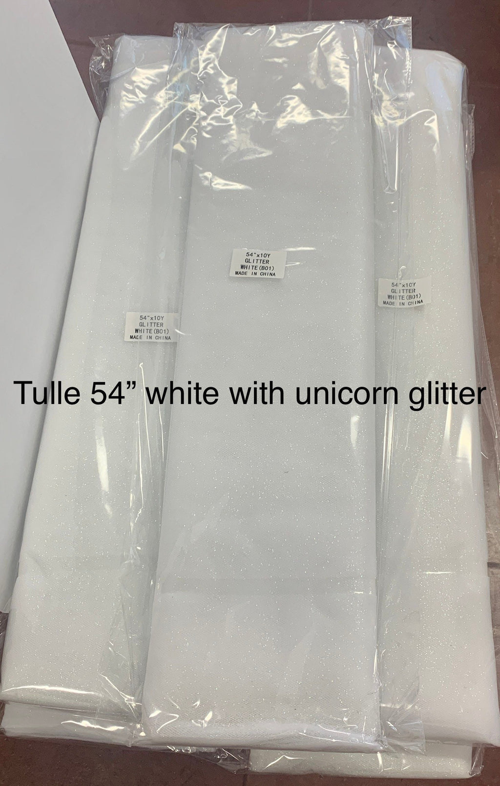 White Glitter Tulle 54" double fold, color White with unicorn glitter 10 yards per pack.